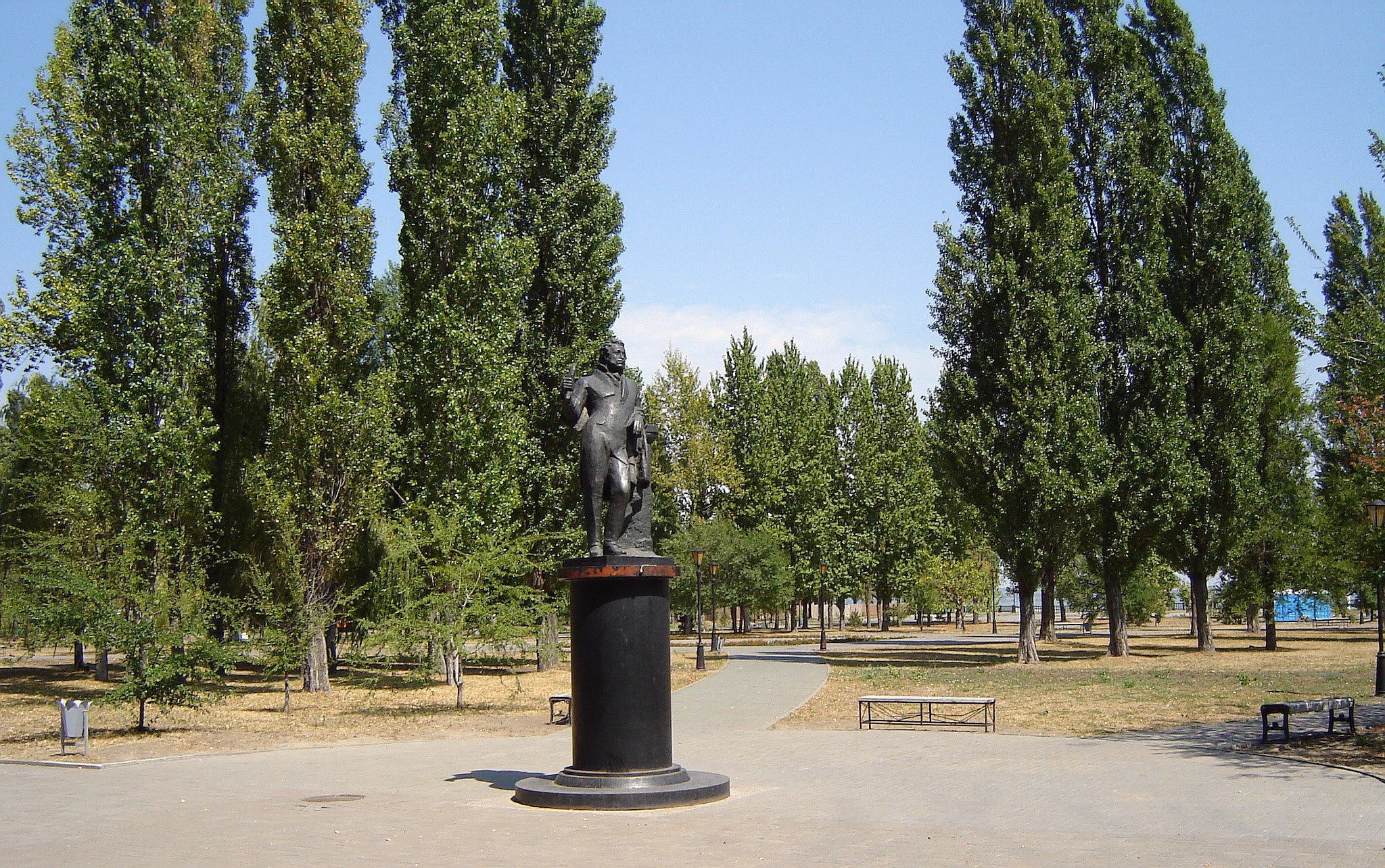 Statue in a park with tall trees HD Wallpaper