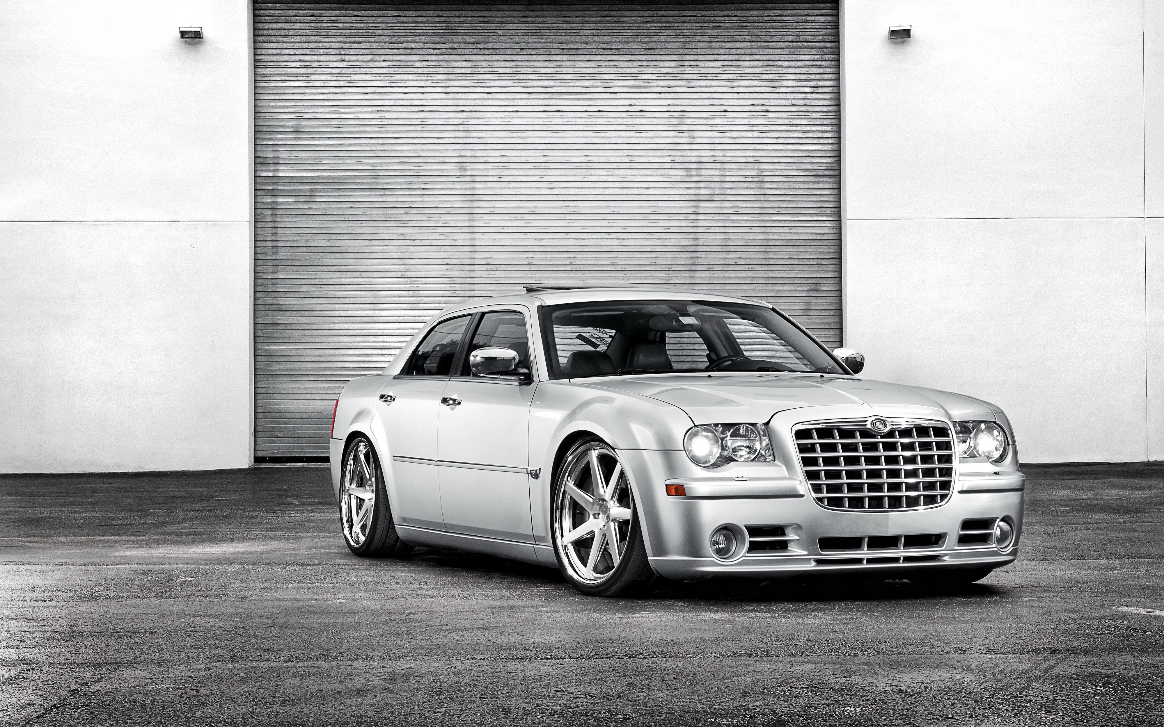 Chrysler 300 sedan parked in front of a garage door HD Wallpaper