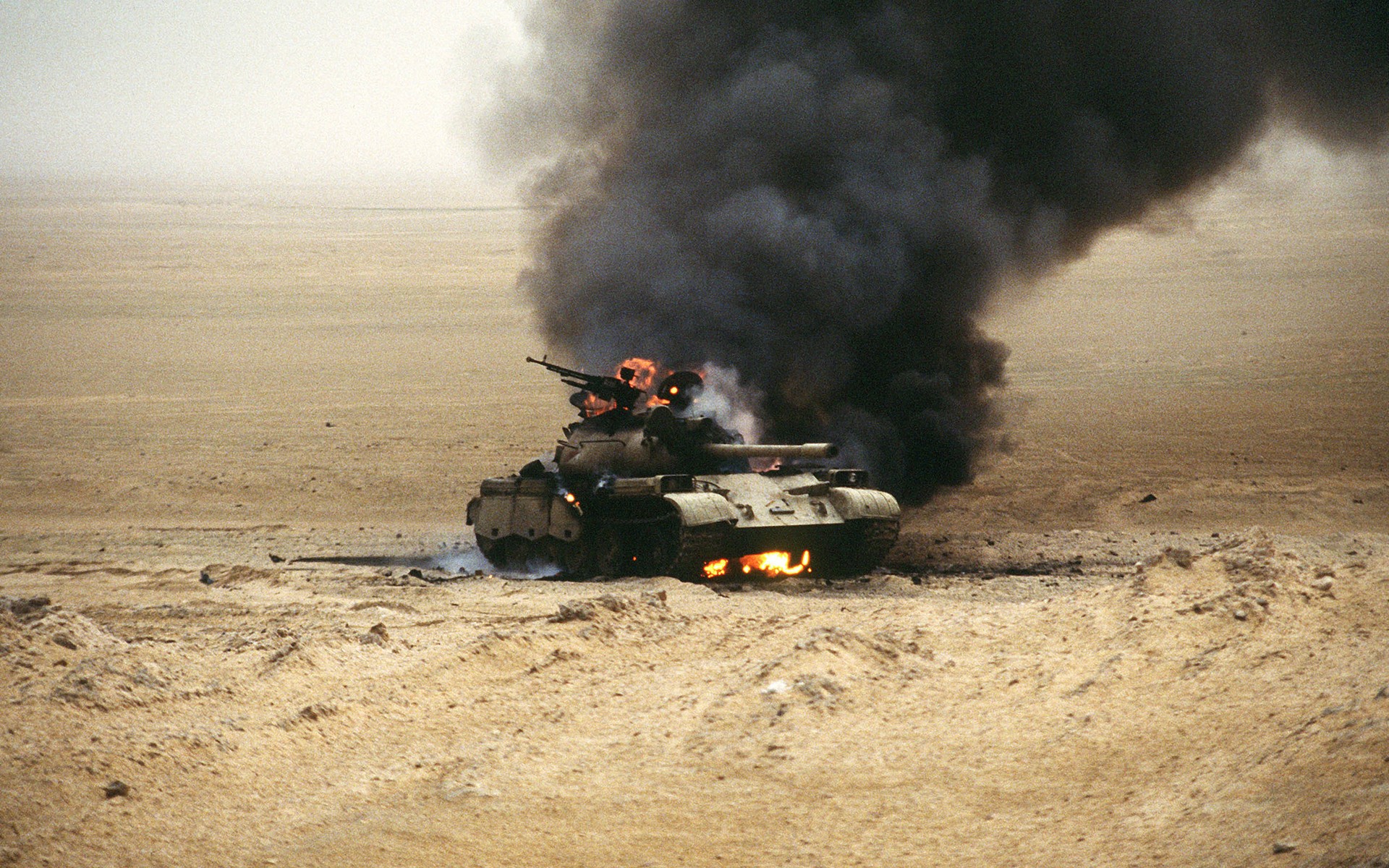 Burning tank in a desert landscape HD Wallpaper