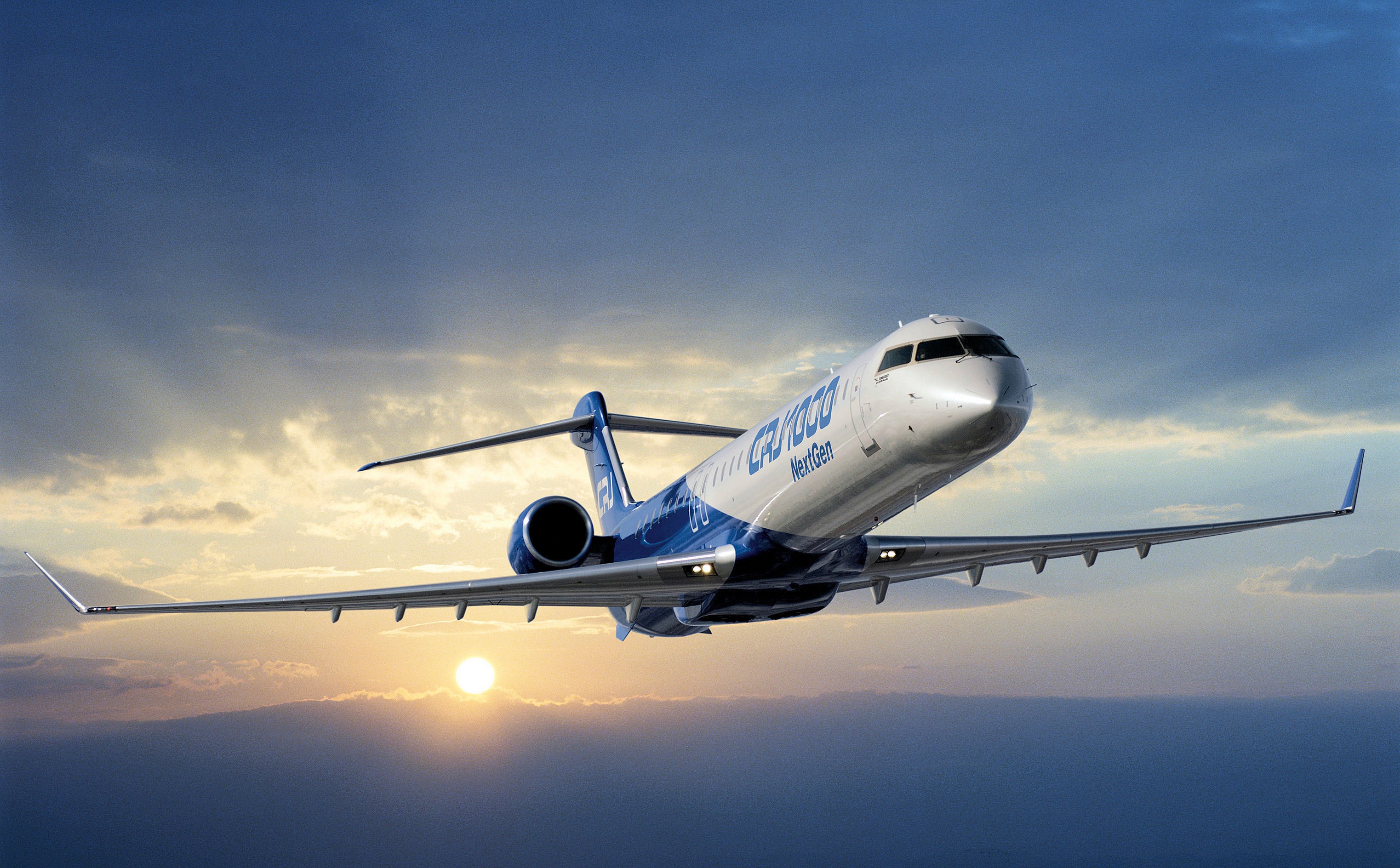 Bombardier CRJ1000 NextGen airplane in flight HD Wallpaper