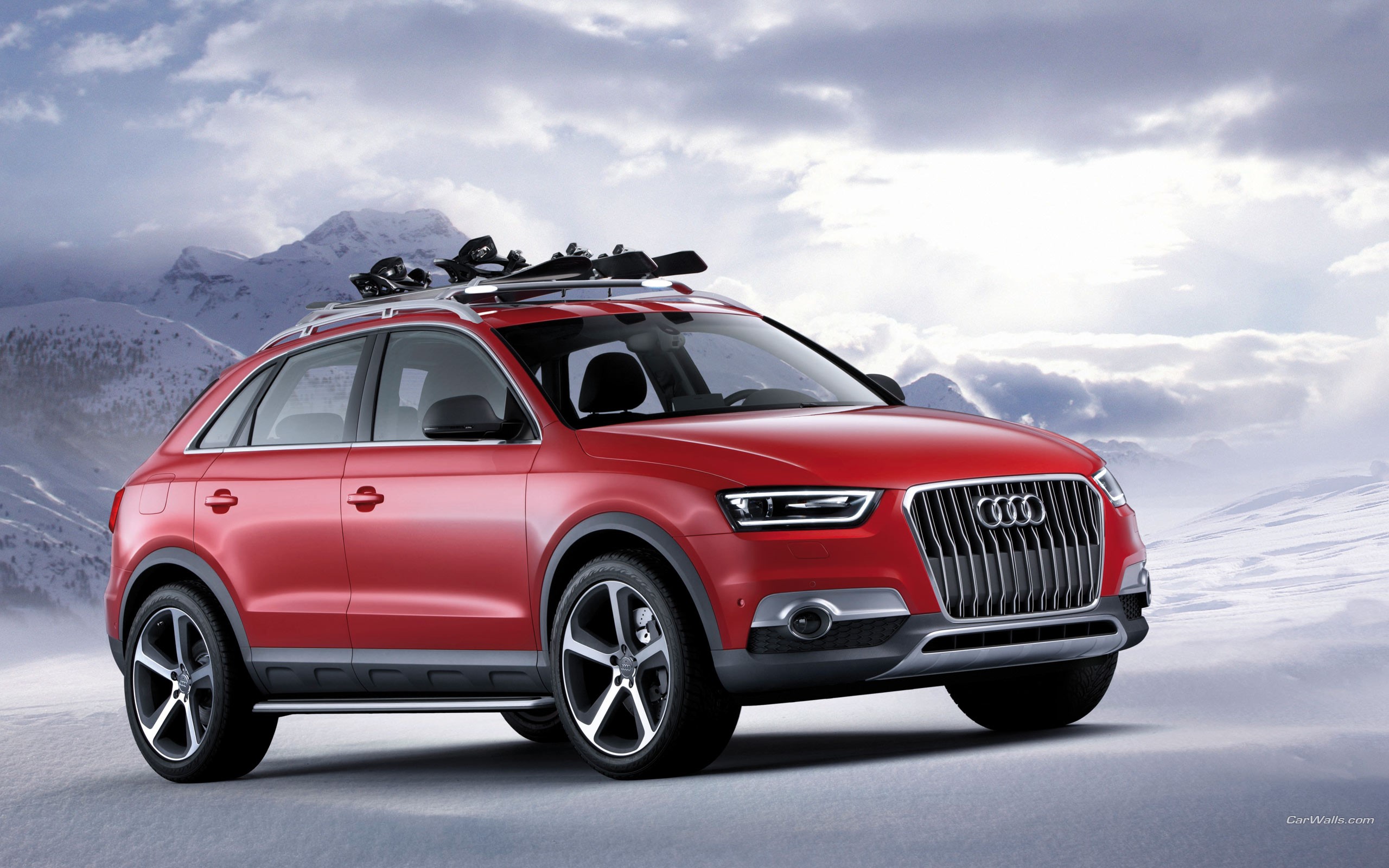 Red Audi Q3 with skis on roof rack HD Wallpaper