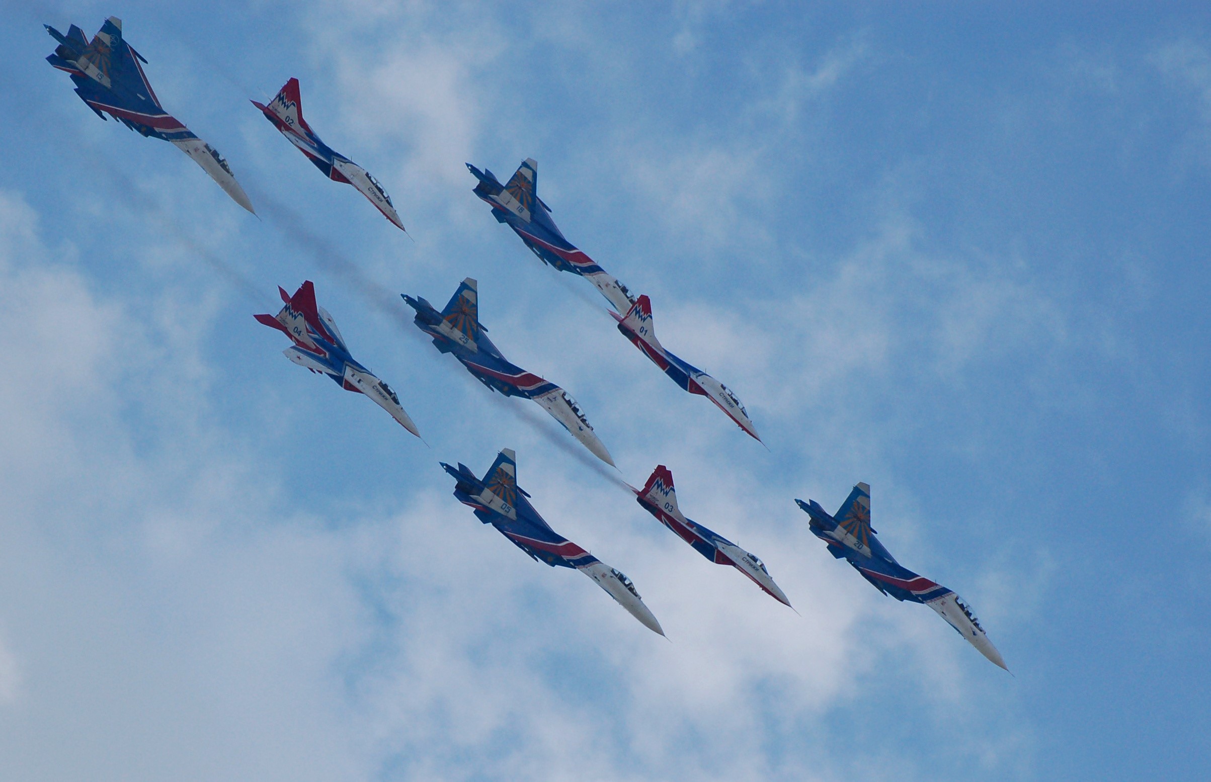 Nine fighter jets flying in formation against a cloudy sky HD Wallpaper