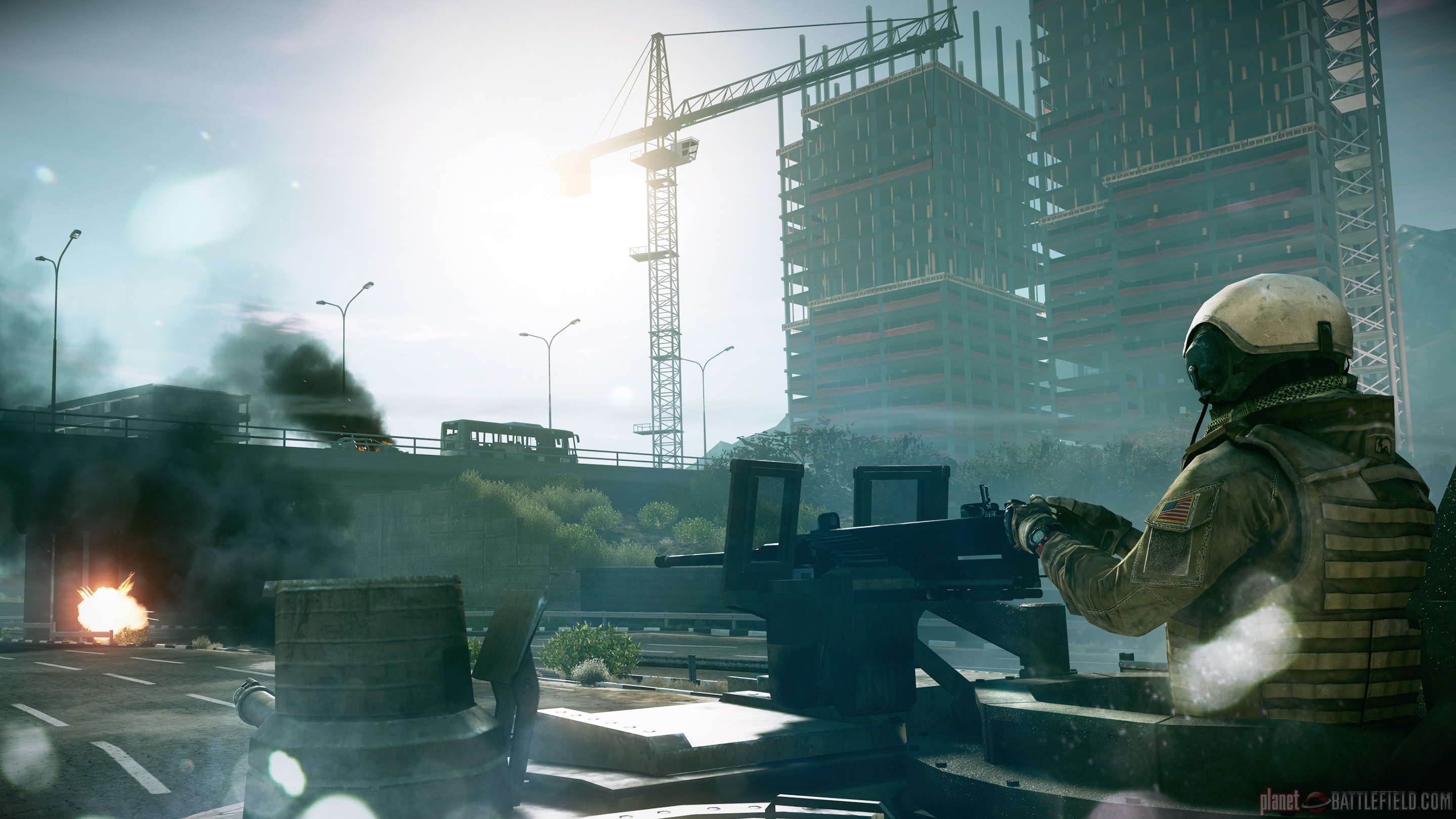 Soldier in Battlefield with burning vehicles and construction site HD Wallpaper