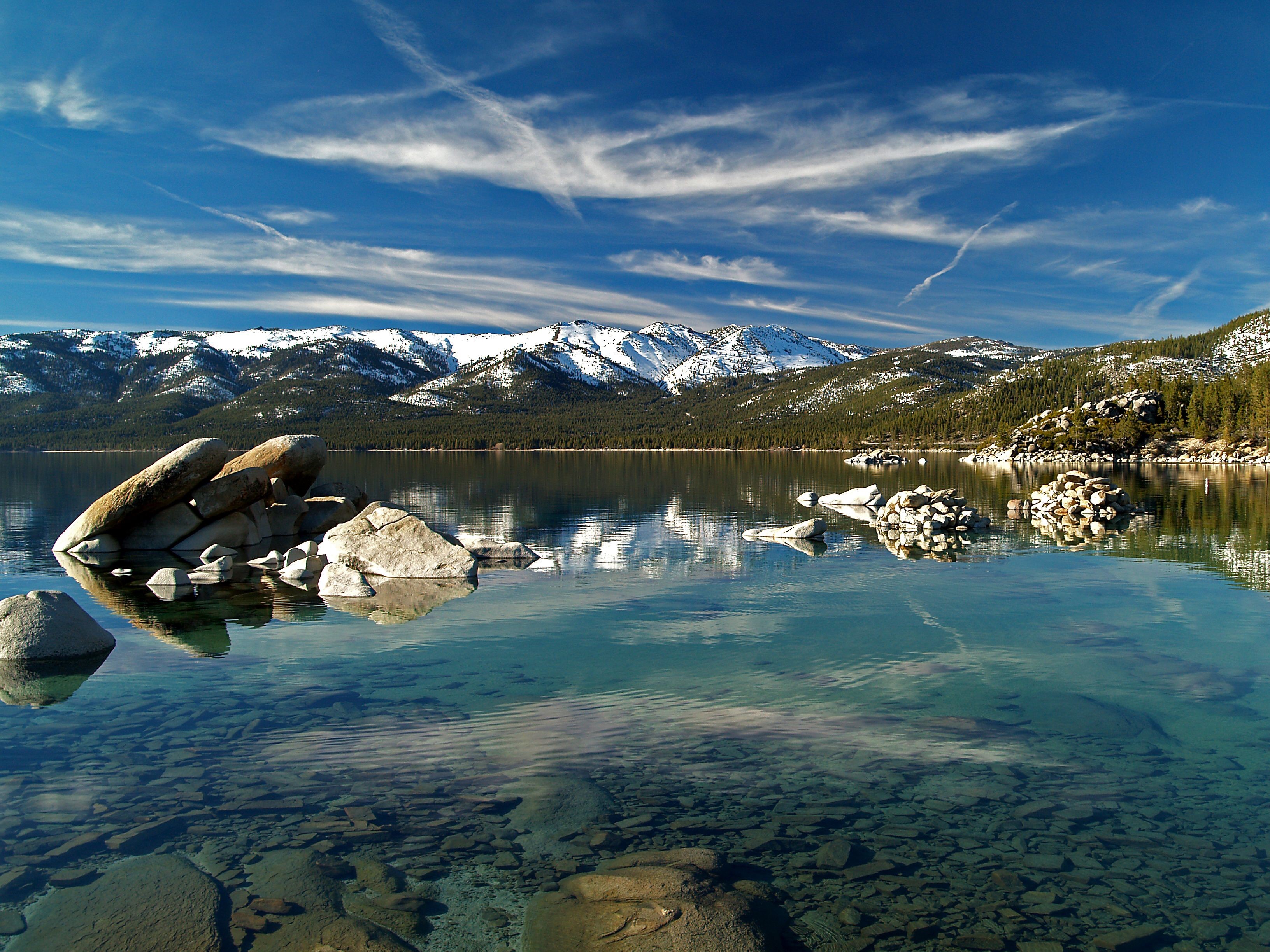 Sand Harbor State Park with snow-capped mountains HD Wallpaper