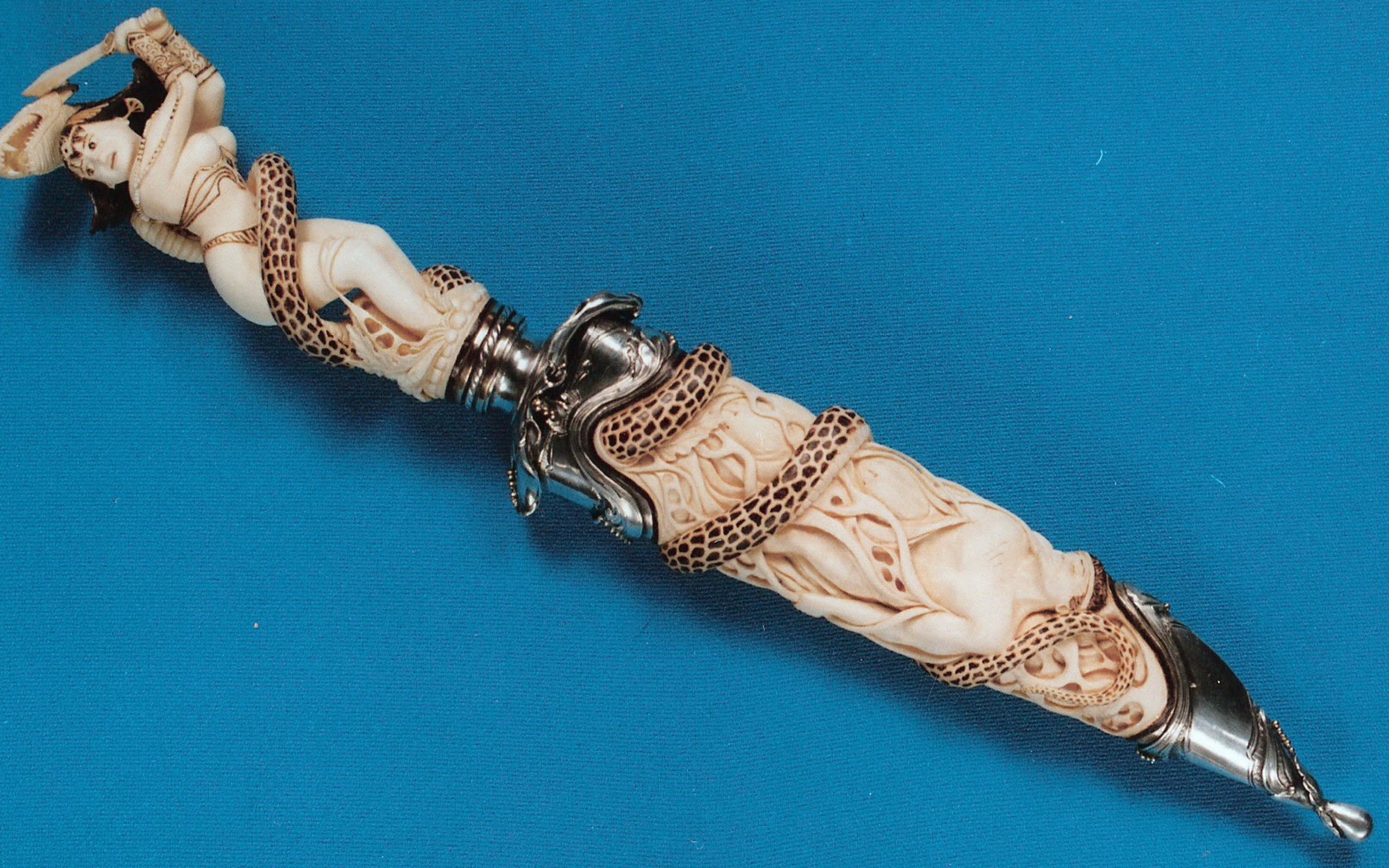 Ornate dagger with carved ivory handle and snake motif HD Wallpaper