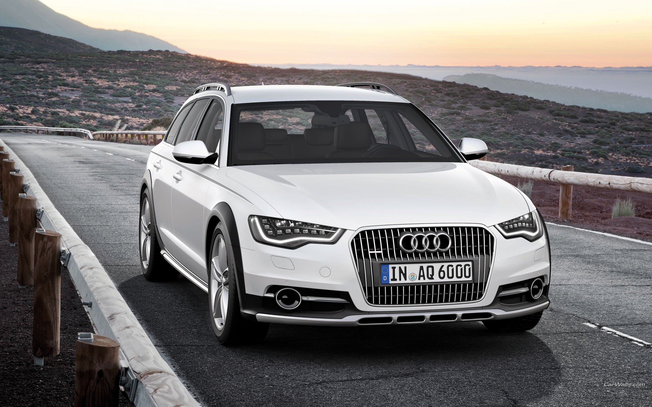 White Audi Allroad Quattro driving on a mountain road HD Wallpaper