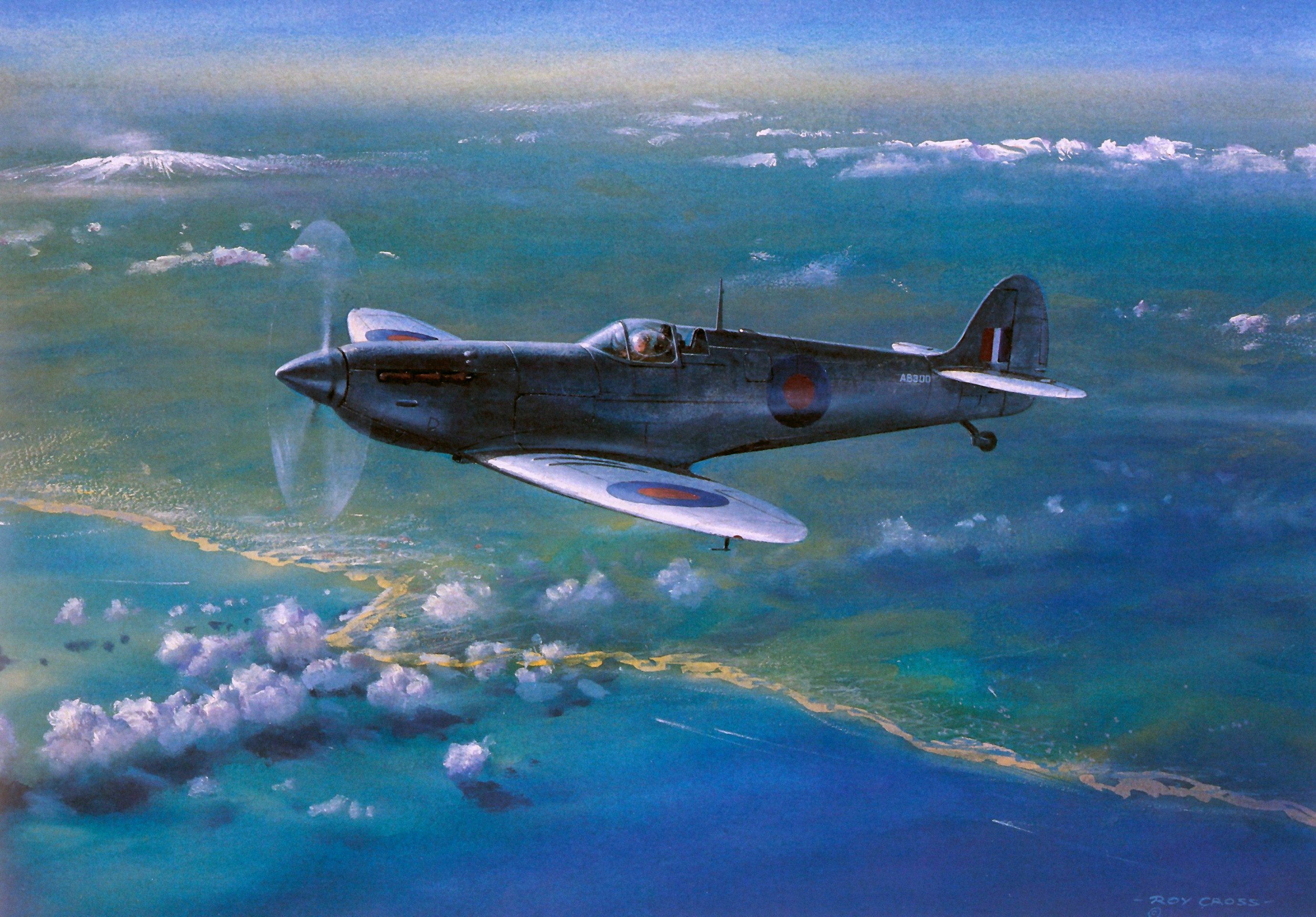 Supermarine Spitfire flying over a coastline HD Wallpaper
