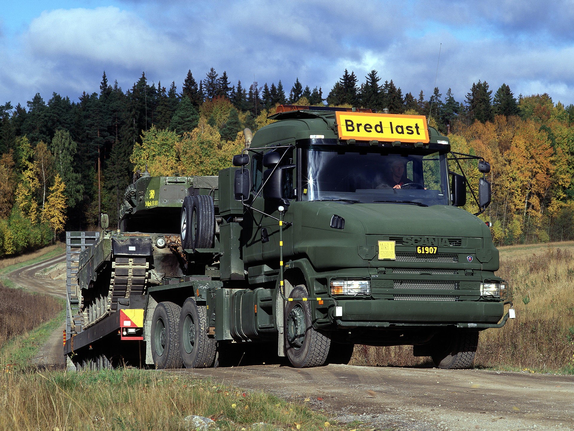 Scania truck carrying a military tank HD Wallpaper