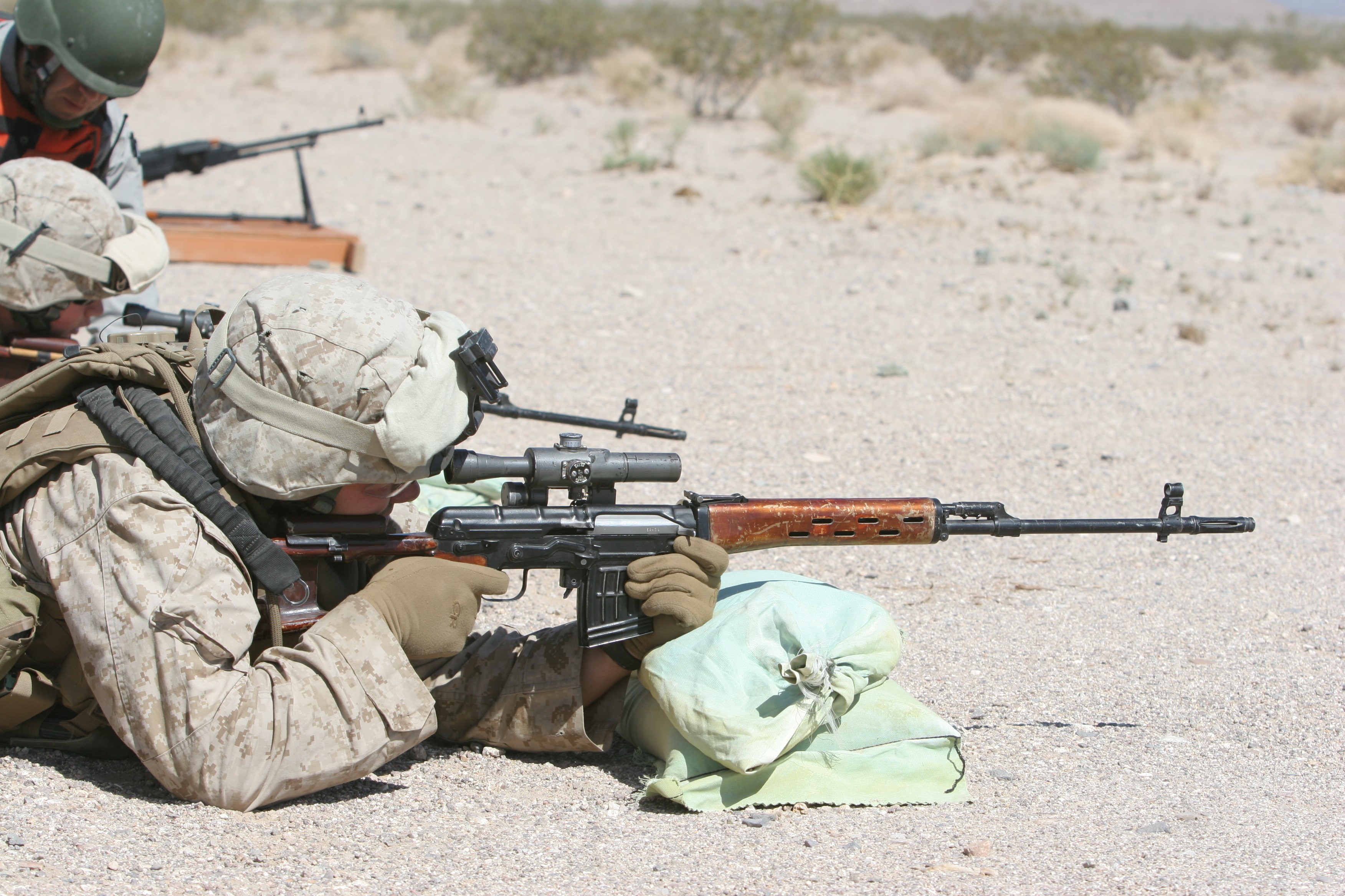 Soldiers aiming sniper rifles in a desert shooting range HD Wallpaper