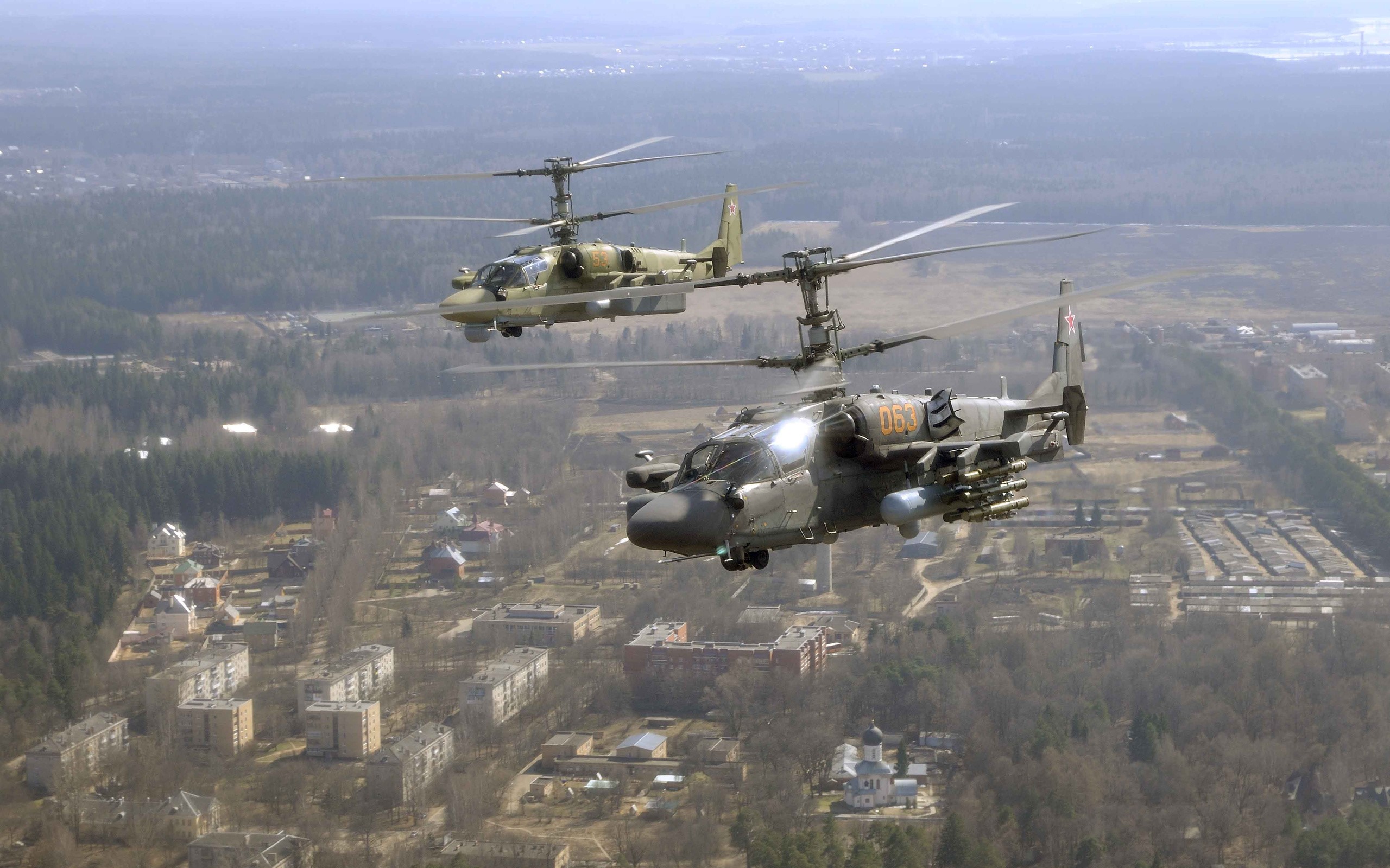 Two Russian Ka-52 Attack Helicopters Flying Over a Town HD Wallpaper