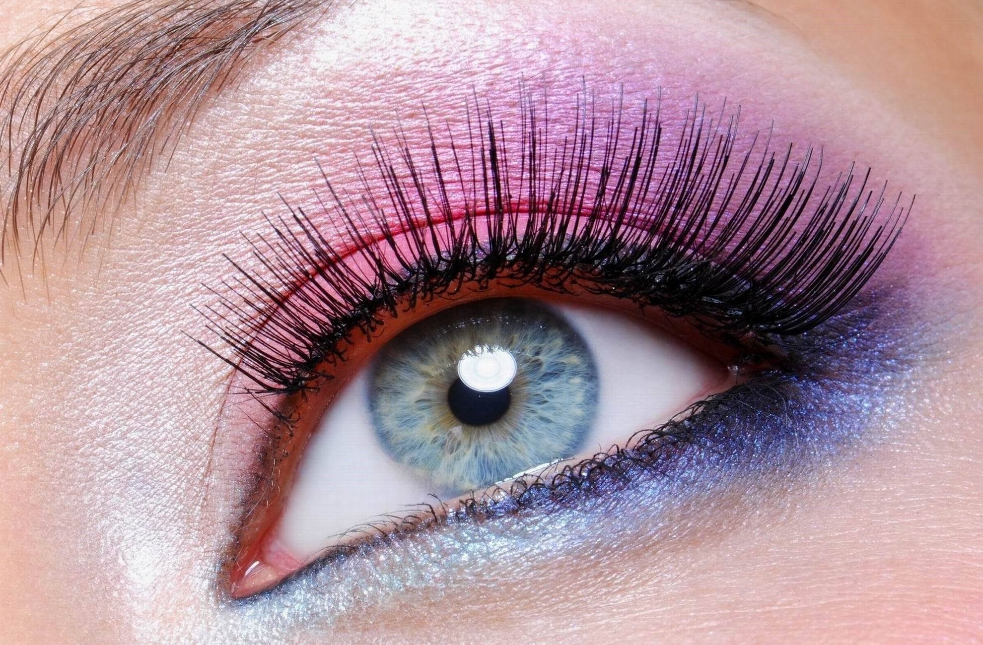 Close-up of a blue eye with pink and purple eyeshadow and false eyelashes HD Wallpaper