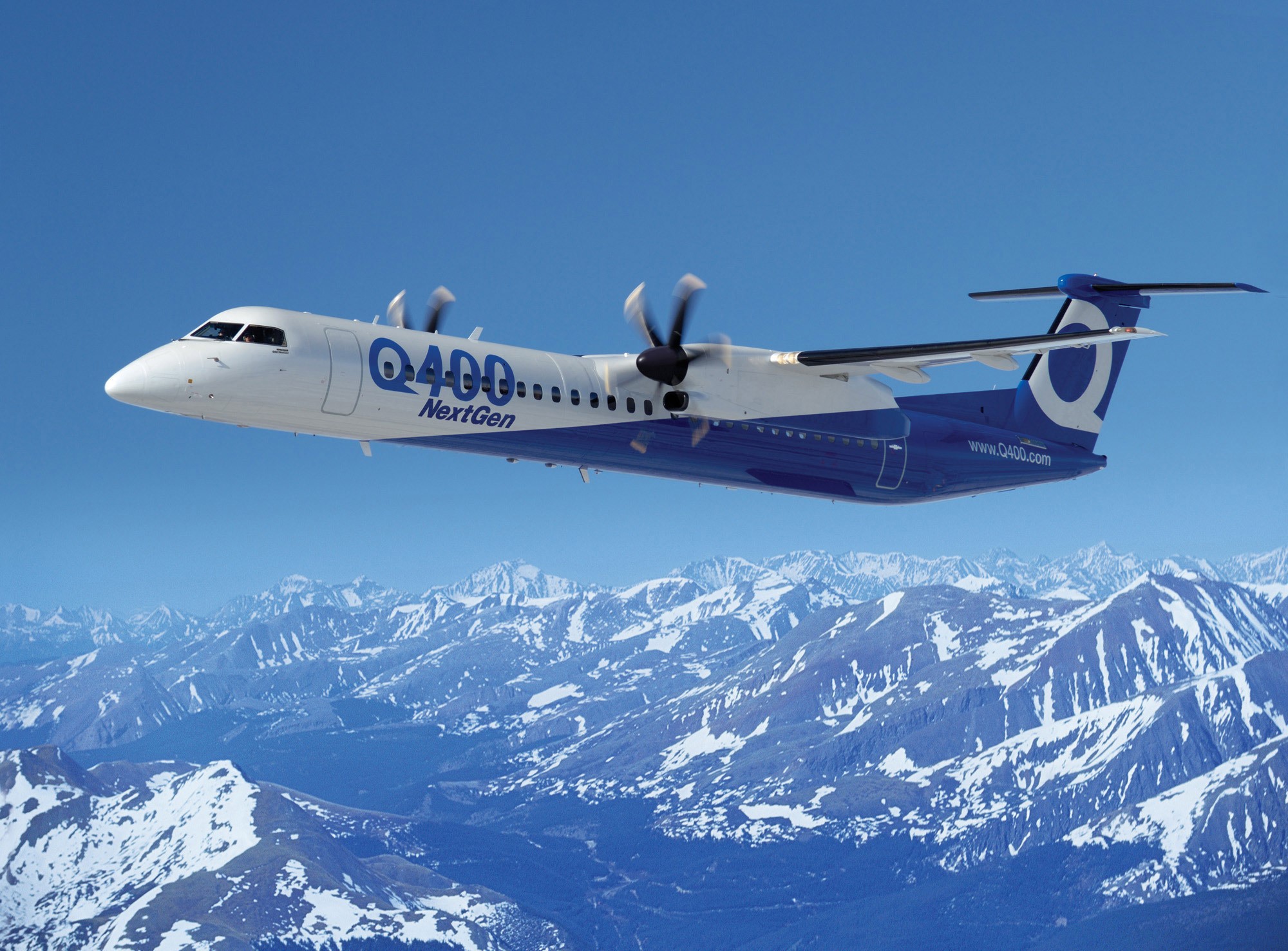 Bombardier Q400 NextGen turboprop airplane flying over mountains HD Wallpaper
