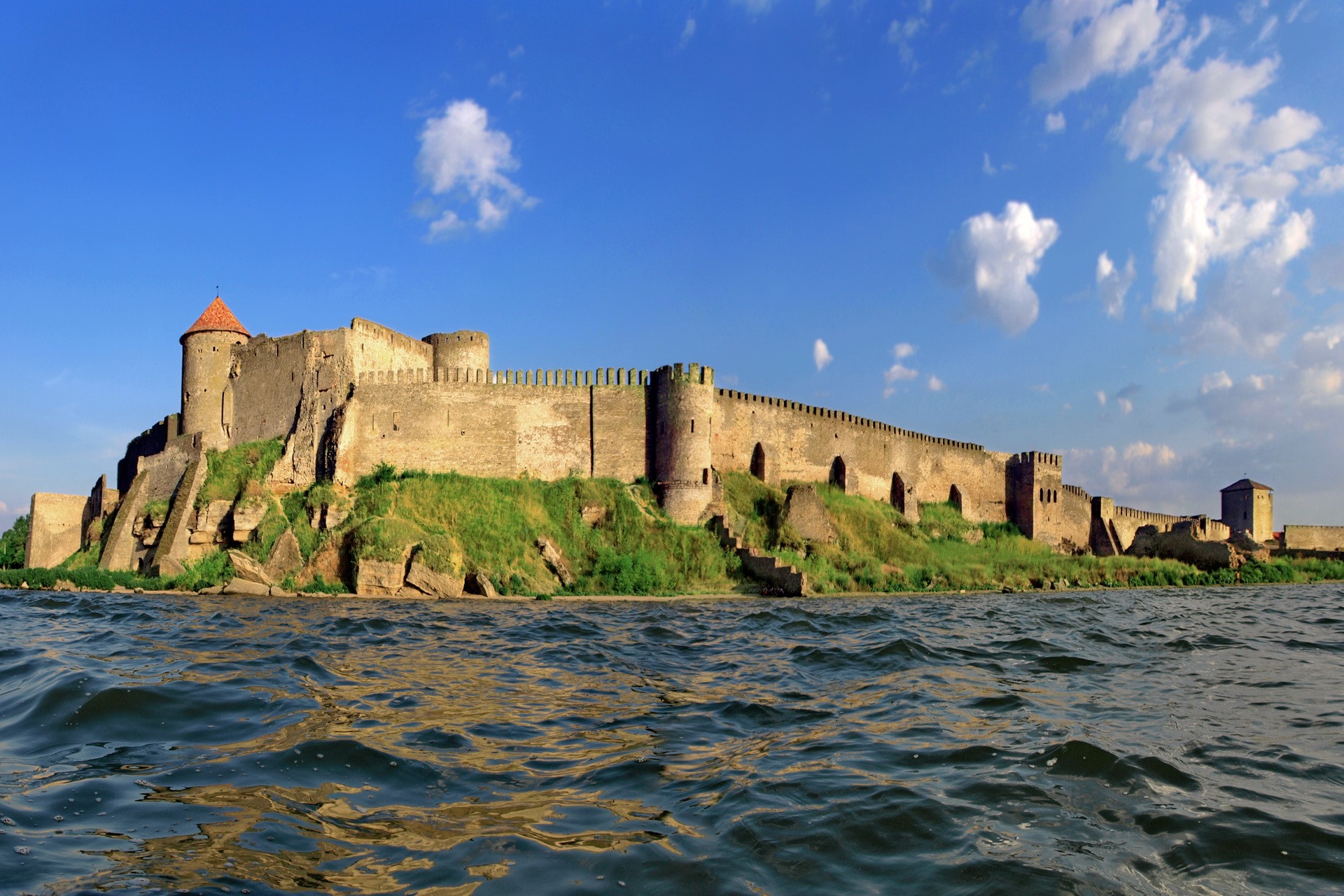 Akkerman Fortress on a rocky shore under a blue sky HD Wallpaper