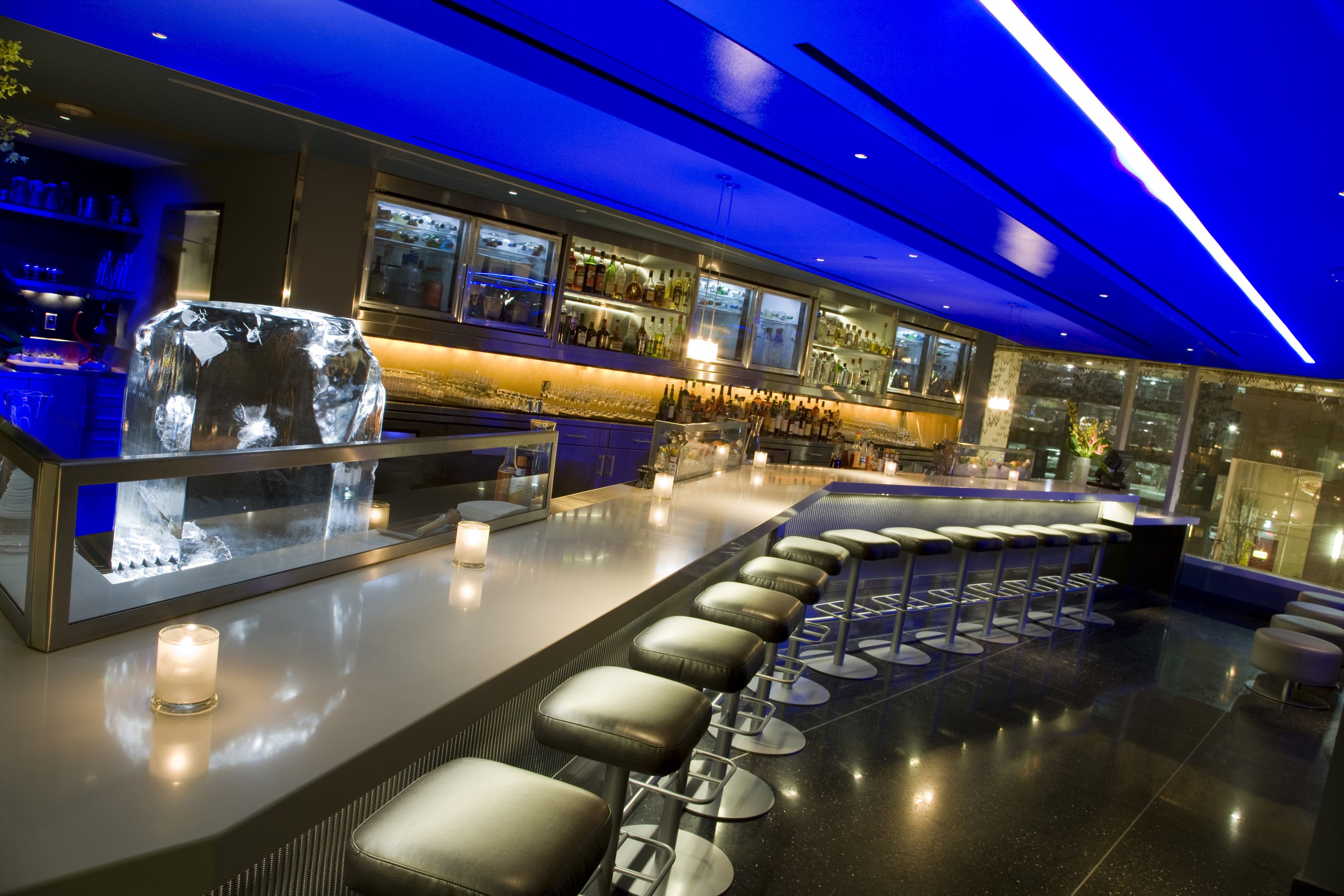 Modern bar interior with blue lighting and ice sculpture HD Wallpaper