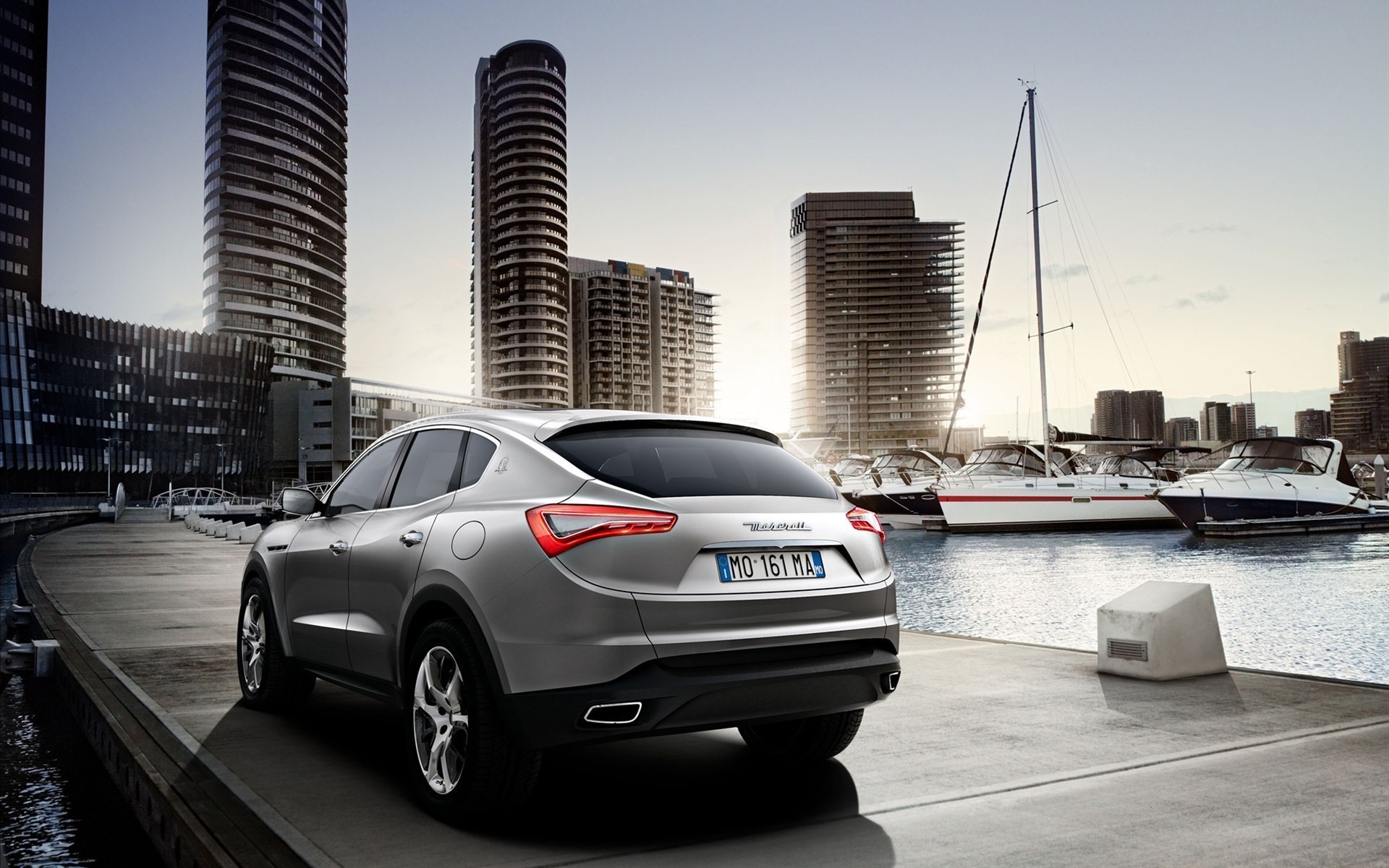 Maserati car parked by a marina with skyscrapers HD Wallpaper