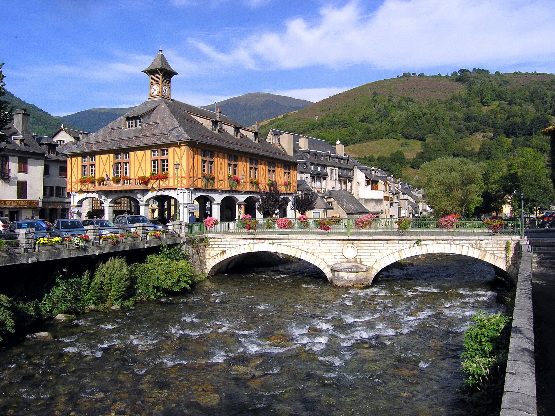 Town hall with clock tower over river and bridge in France HD Wallpaper