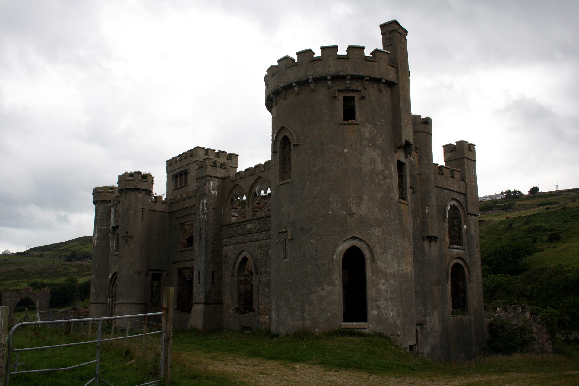 Ruined castle on a grassy hill under a cloudy sky HD Wallpaper