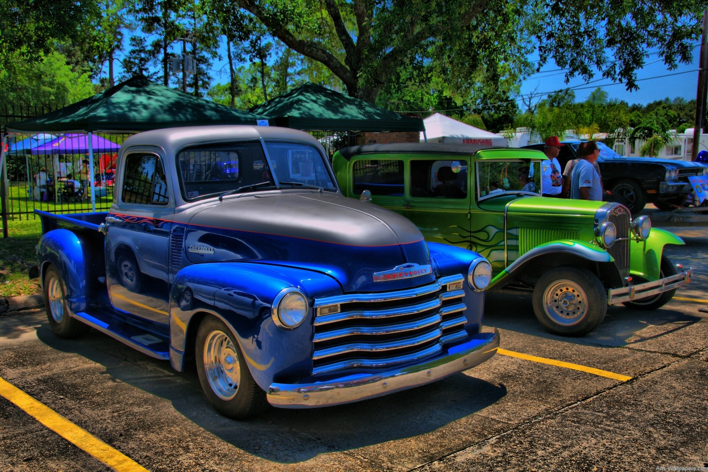 Retro Chevrolet and Ford trucks at an outdoor car show HD Wallpaper