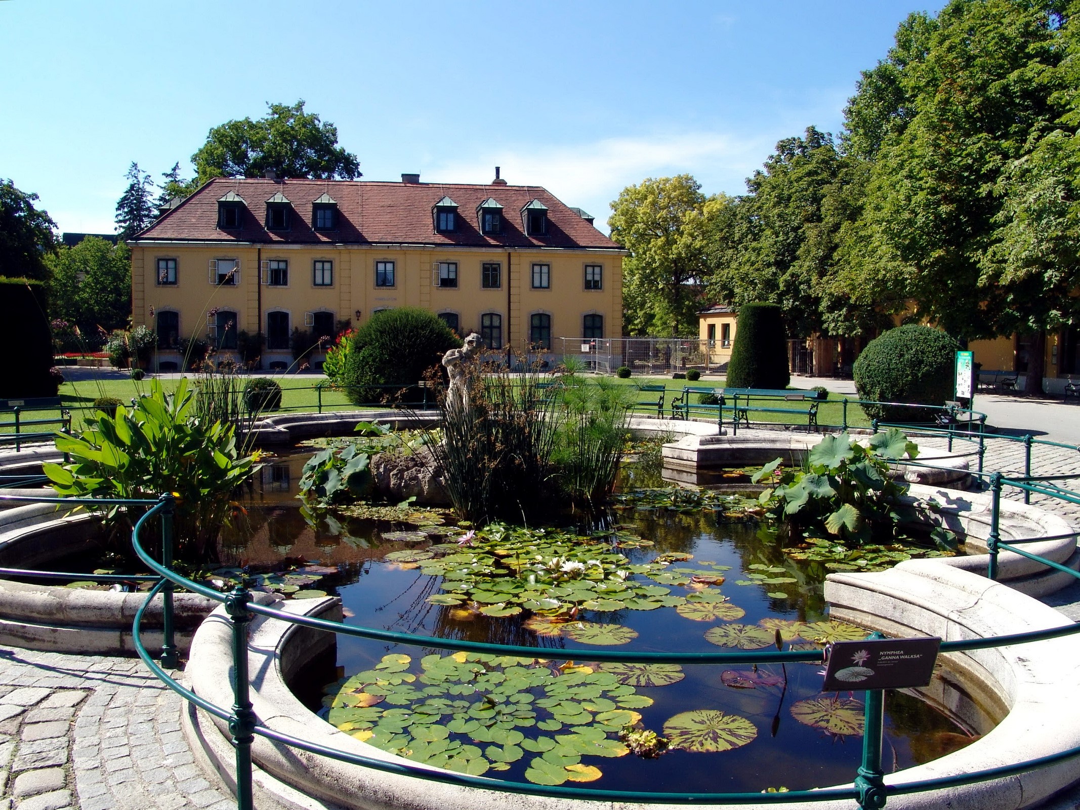 Palace garden with pond and building in Vienna, Austria HD Wallpaper