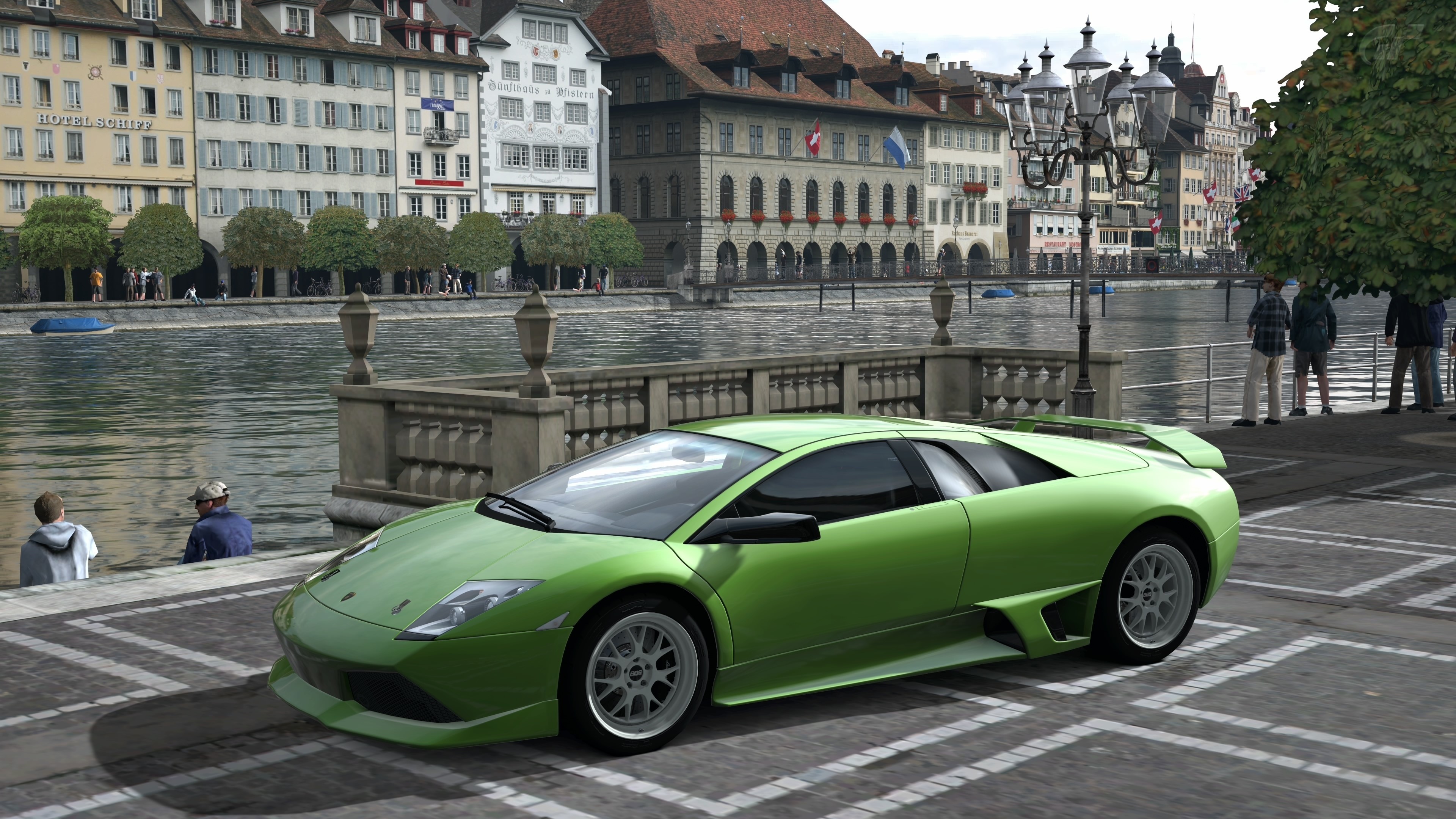 Green Lamborghini parked by a river in a European city HD Wallpaper