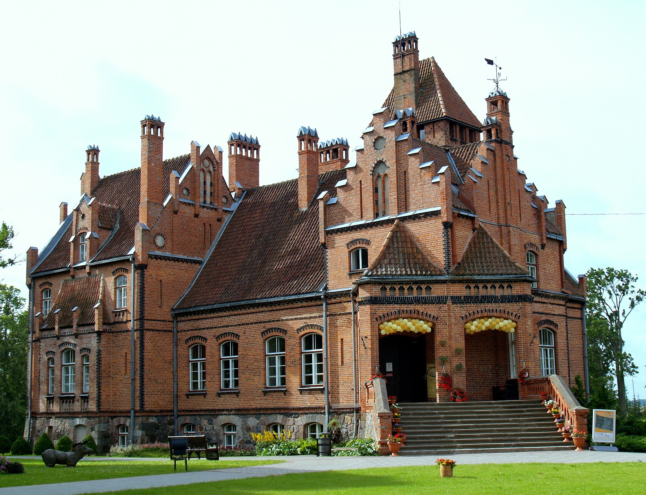 Brick castle with ornate chimneys and a grand staircase HD Wallpaper