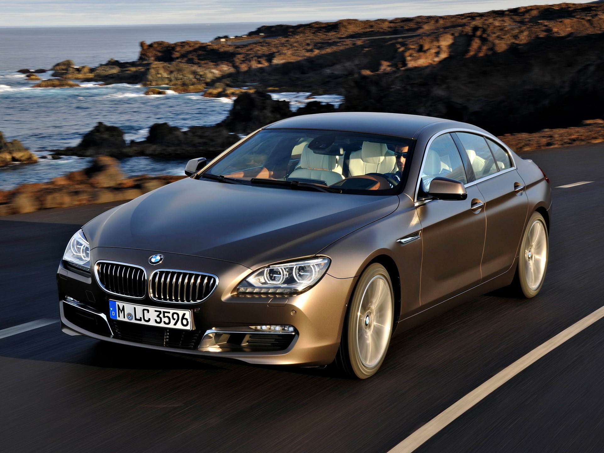 BMW 6 Series Gran Coupe driving on a coastal road HD Wallpaper