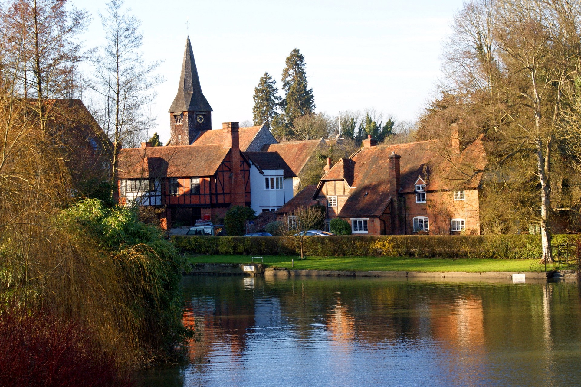Houses and church by a river in the United Kingdom HD Wallpaper
