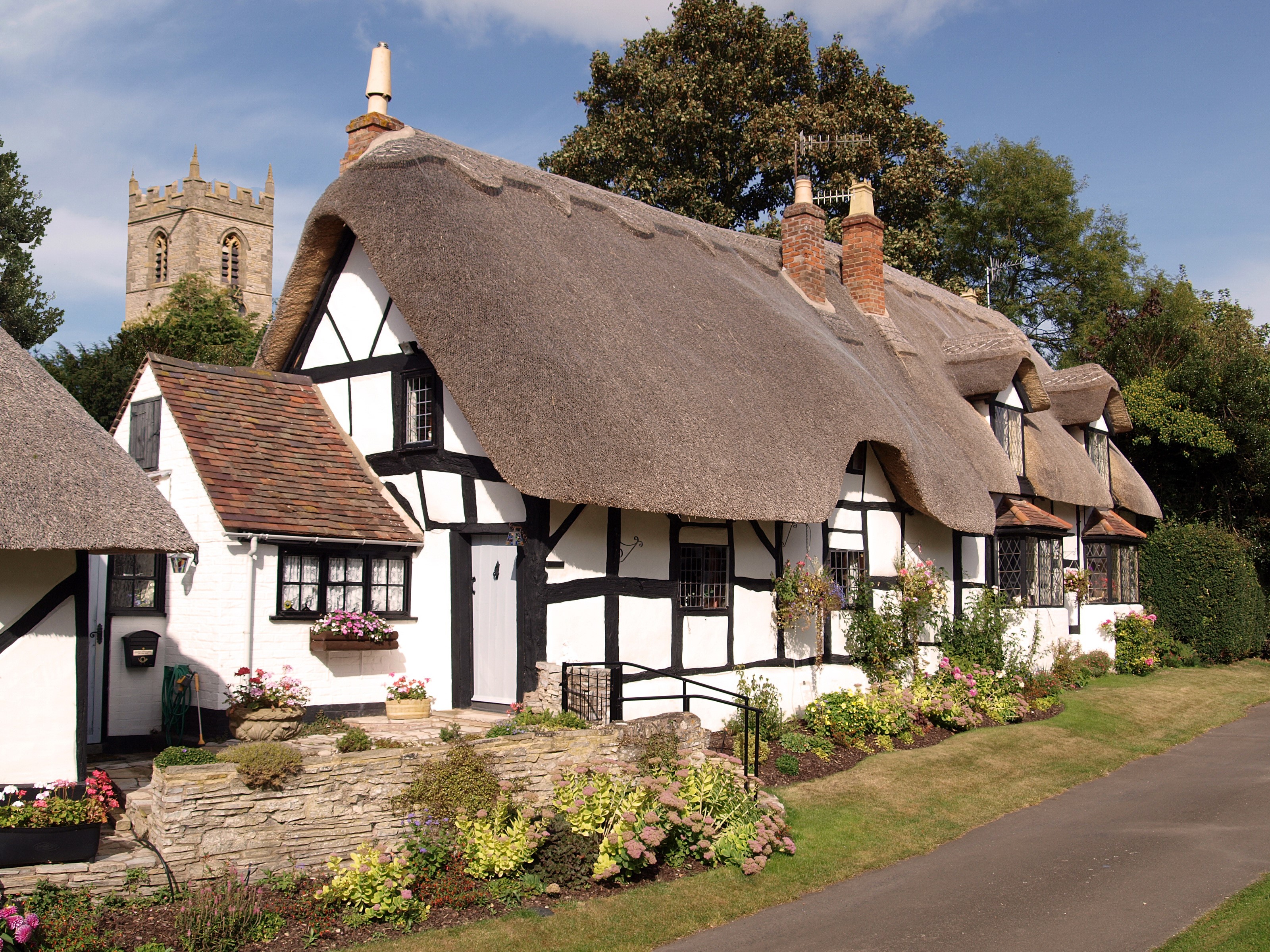 Thatched Cottages and Church Tower in the United Kingdom HD Wallpaper