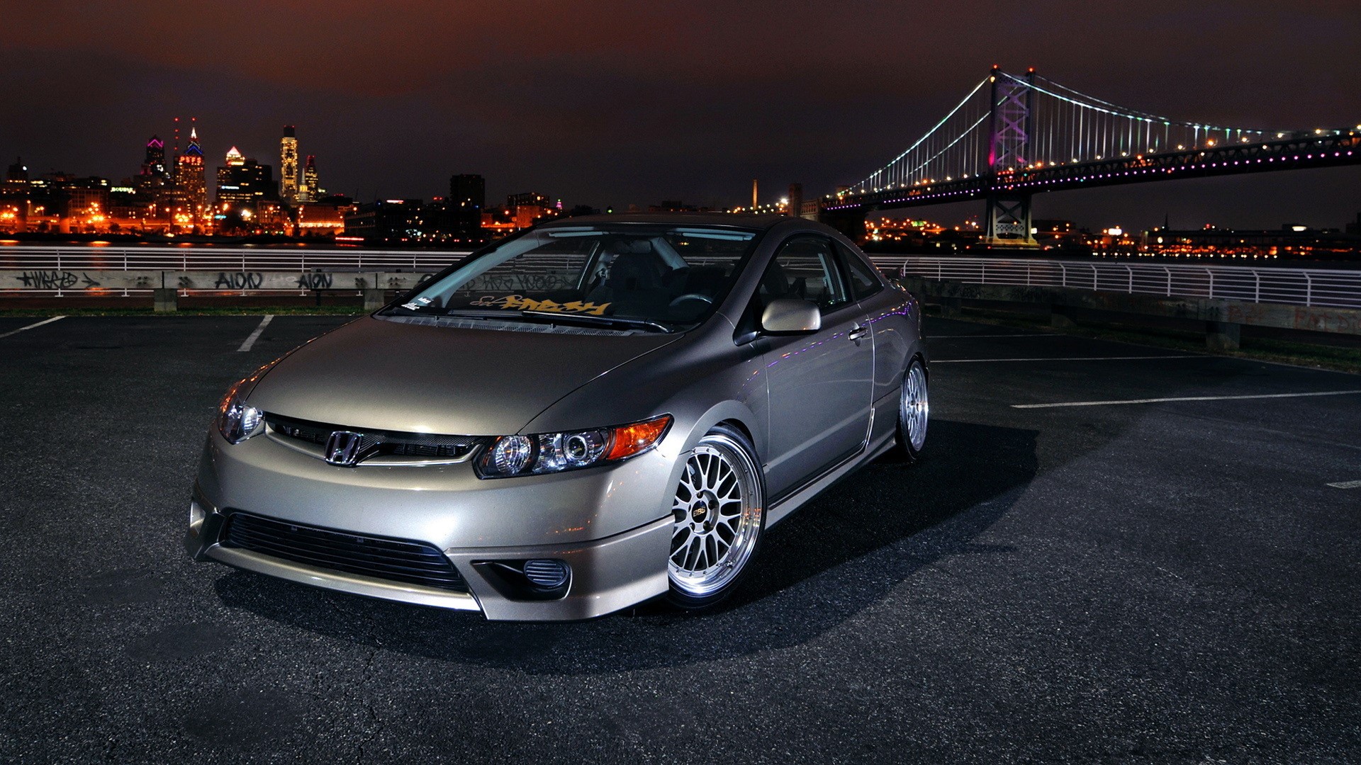 Honda Civic Coupe parked at night with city skyline and bridge HD Wallpaper