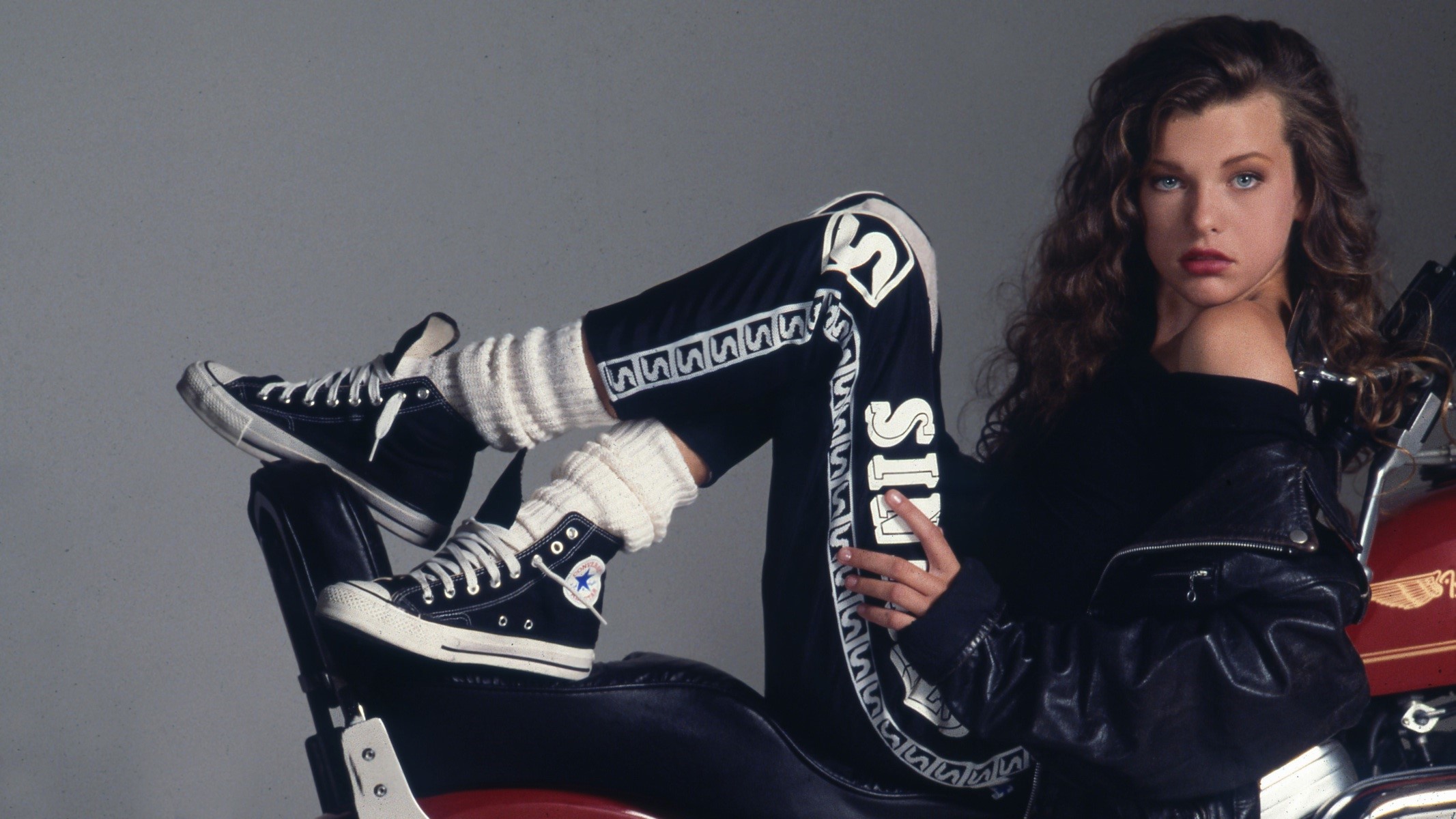 Milla Jovovich posing on a motorcycle HD Wallpaper