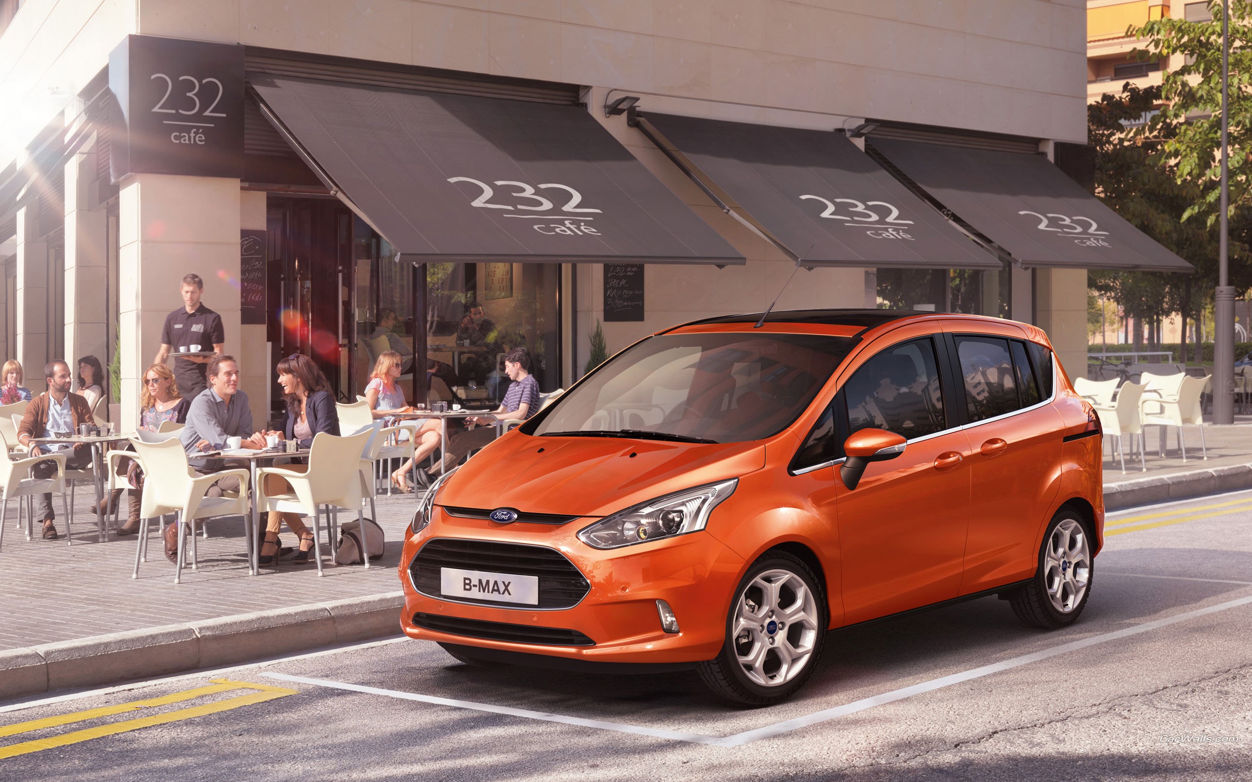 Orange Ford B-Max parked outside a cafe HD Wallpaper