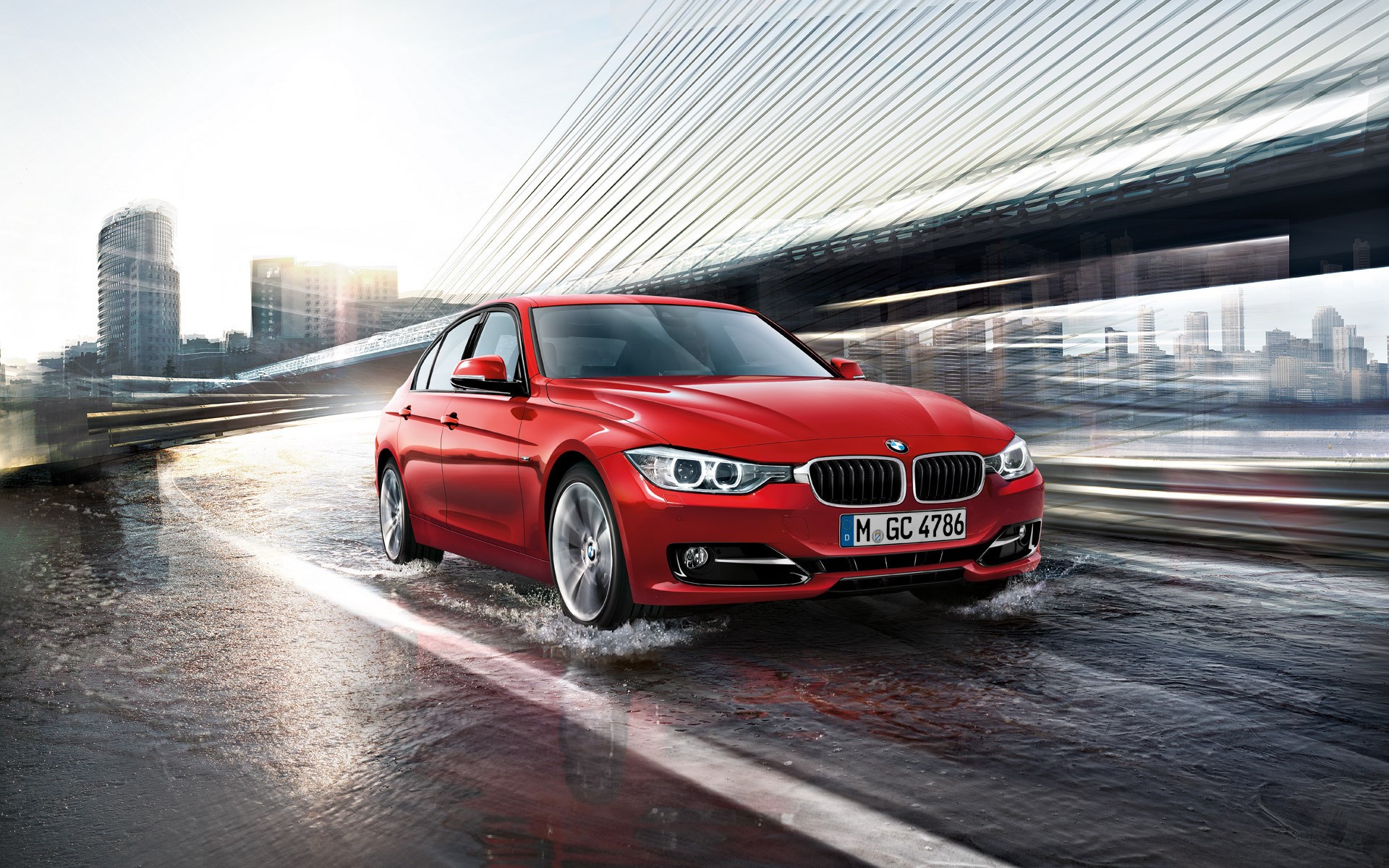 Red BMW driving through water in a city HD Wallpaper