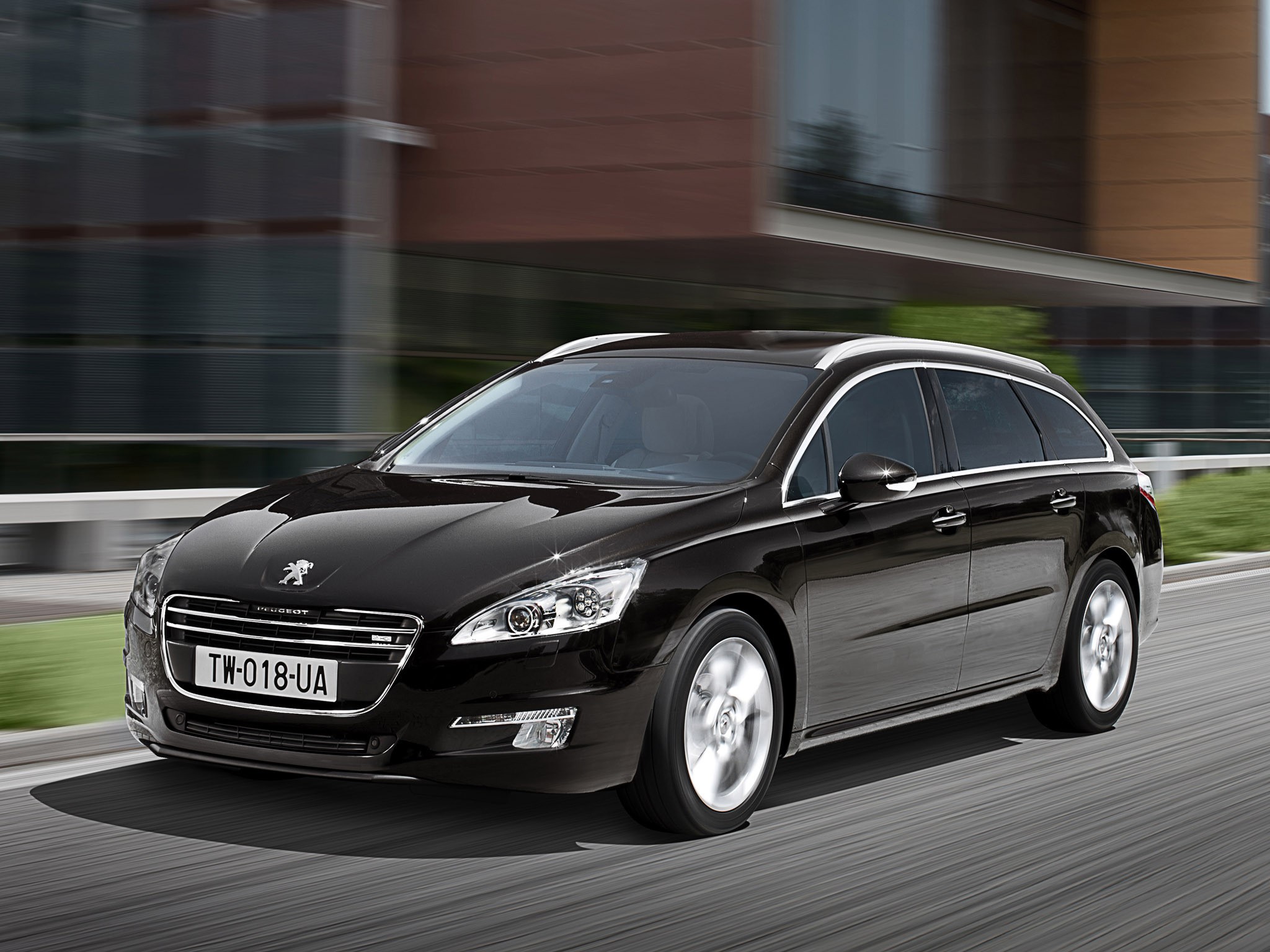 Black Peugeot 508 SW driving on a road HD Wallpaper