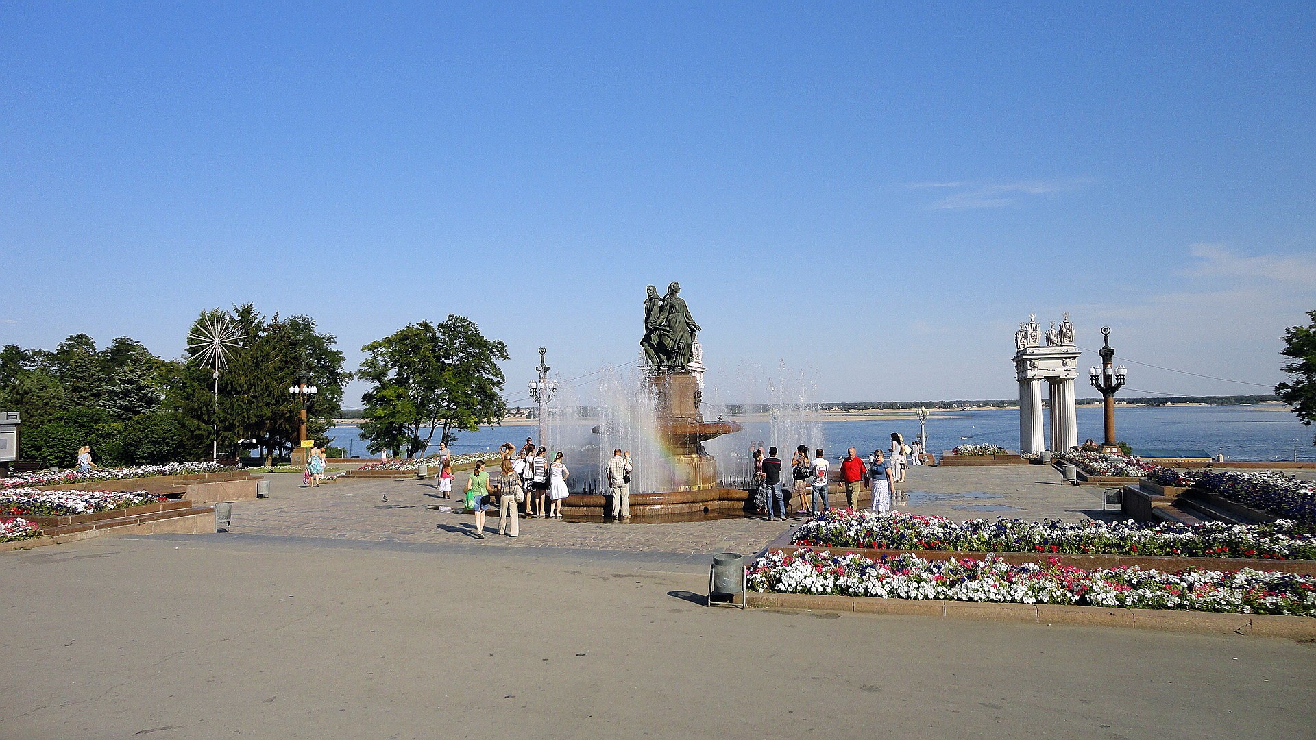 Fountain with people and river HD Wallpaper