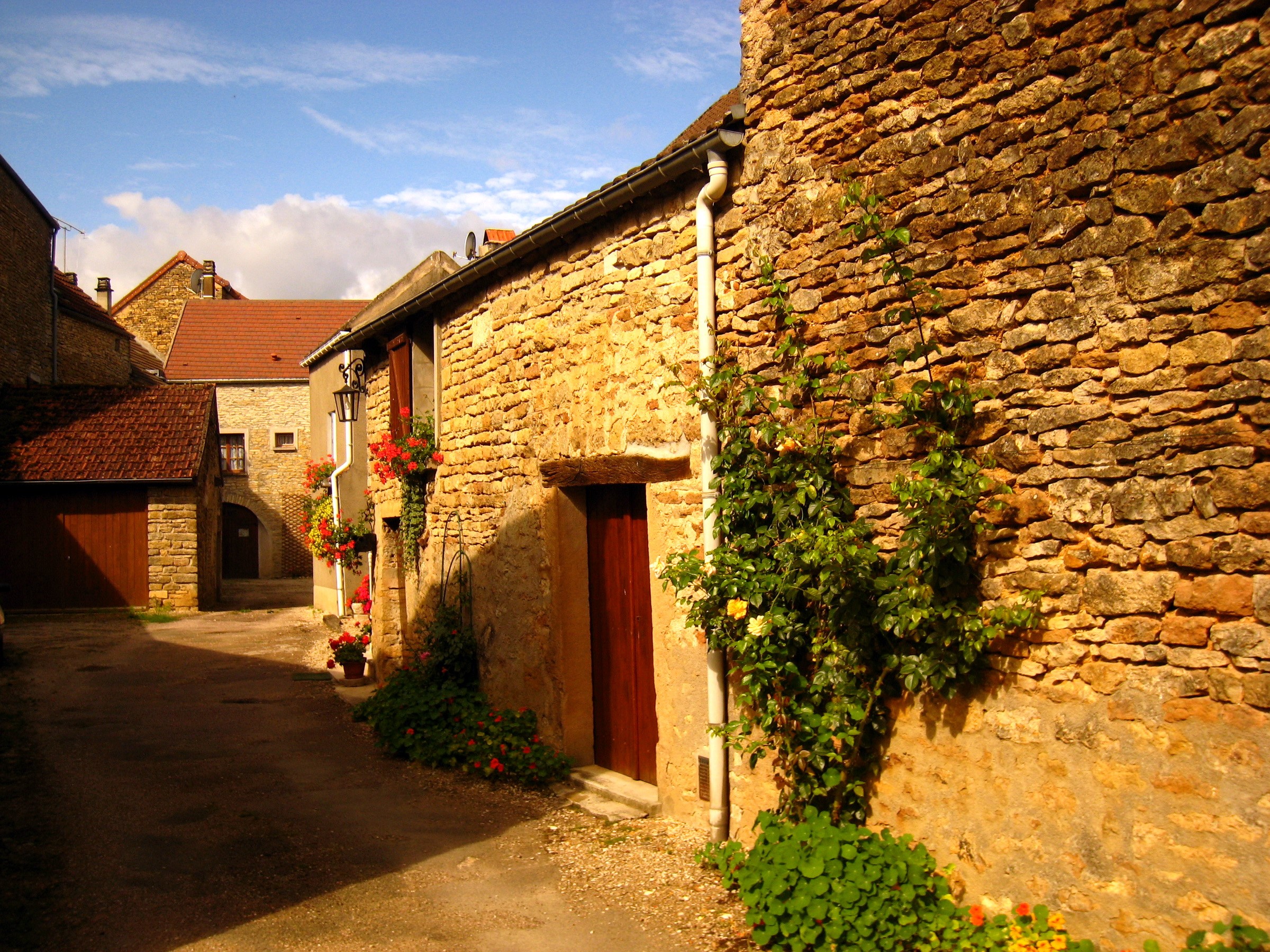 Stone houses on a narrow street in France HD Wallpaper