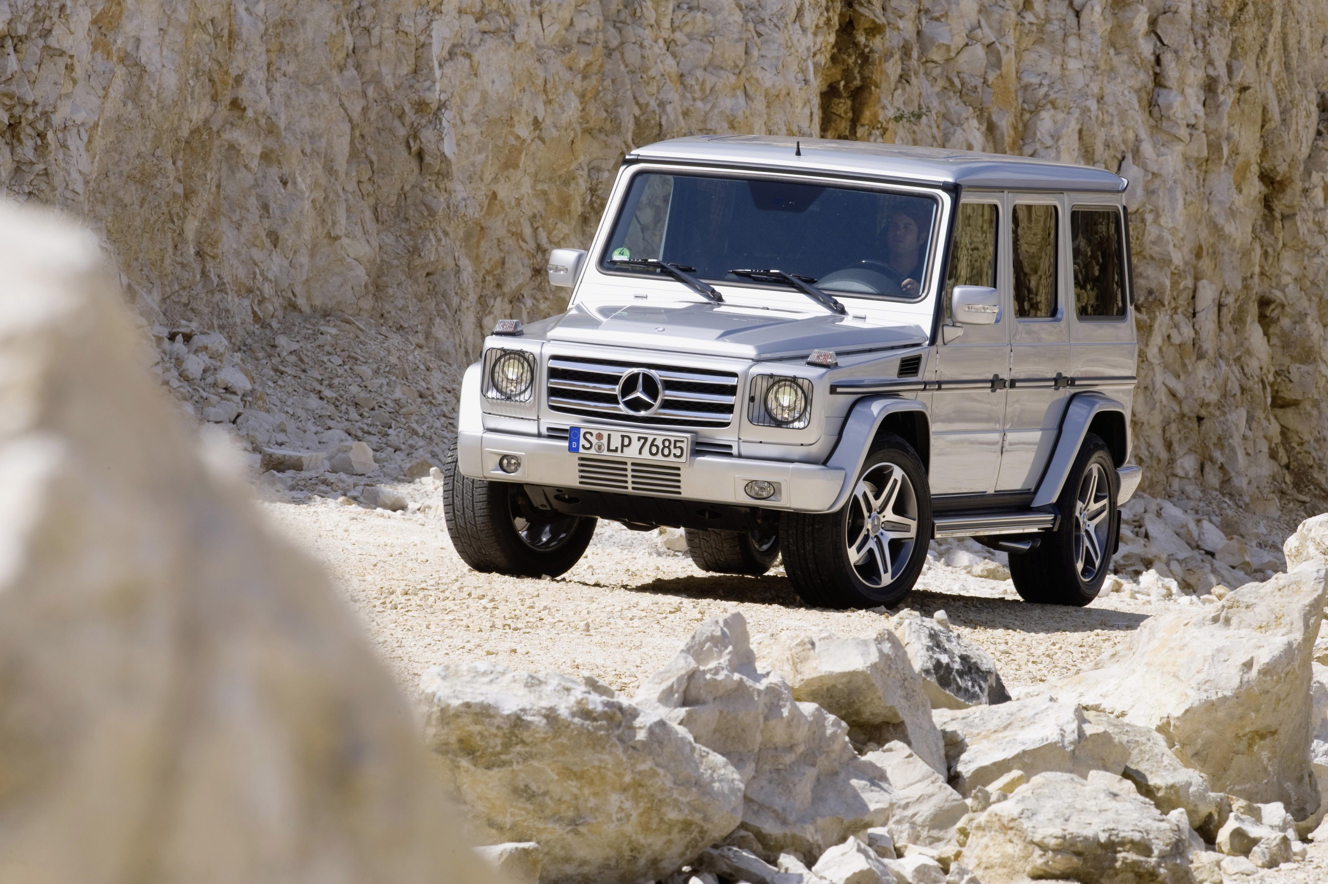 Mercedes-Benz G-Class driving on rocky terrain HD Wallpaper