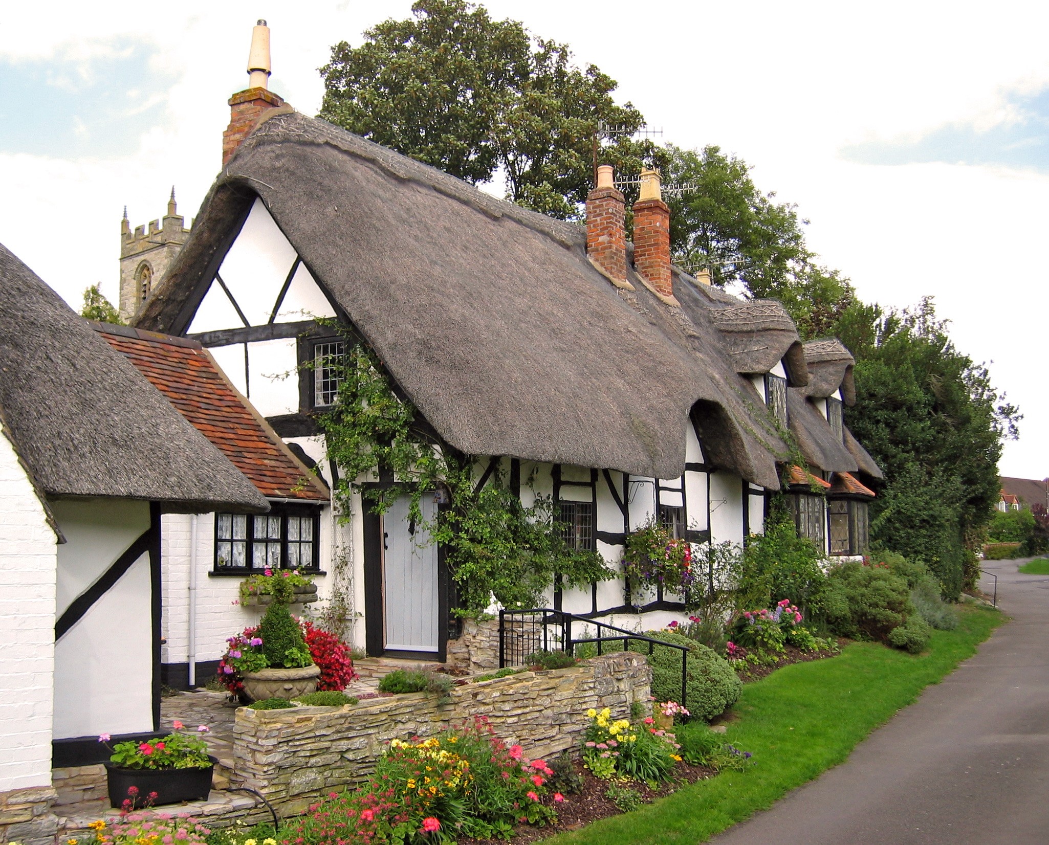 Thatched Cottages and Church Tower in the United Kingdom HD Wallpaper