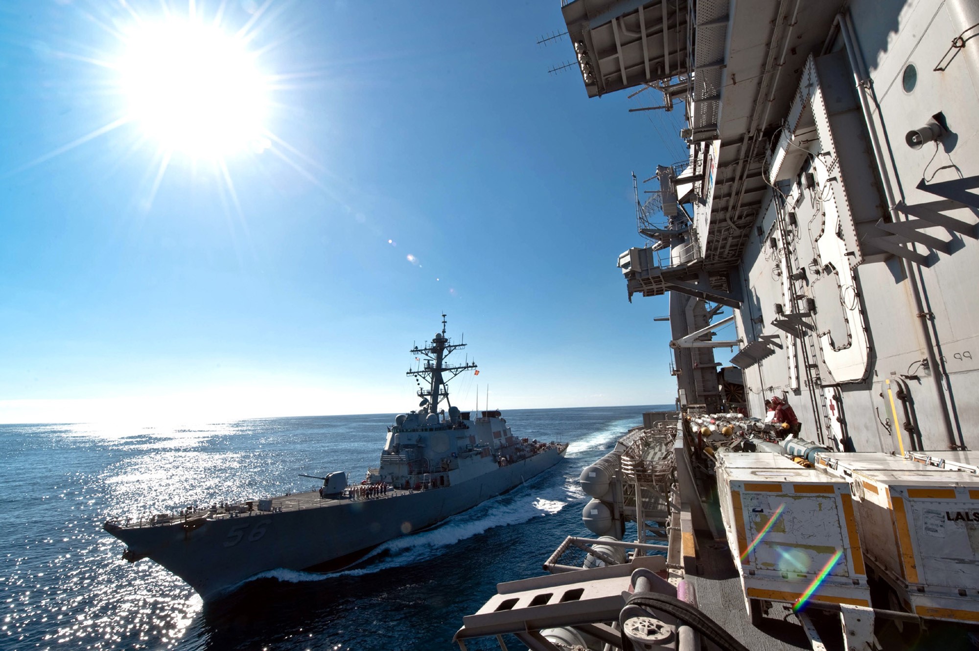 US Navy Destroyer sails alongside aircraft carrier HD Wallpaper