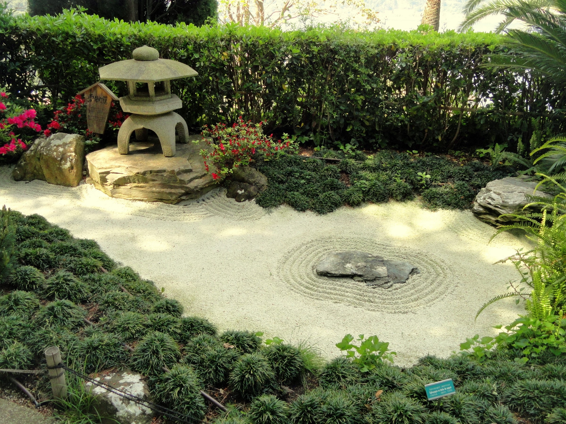 Zen garden with stone lantern and raked sand HD Wallpaper