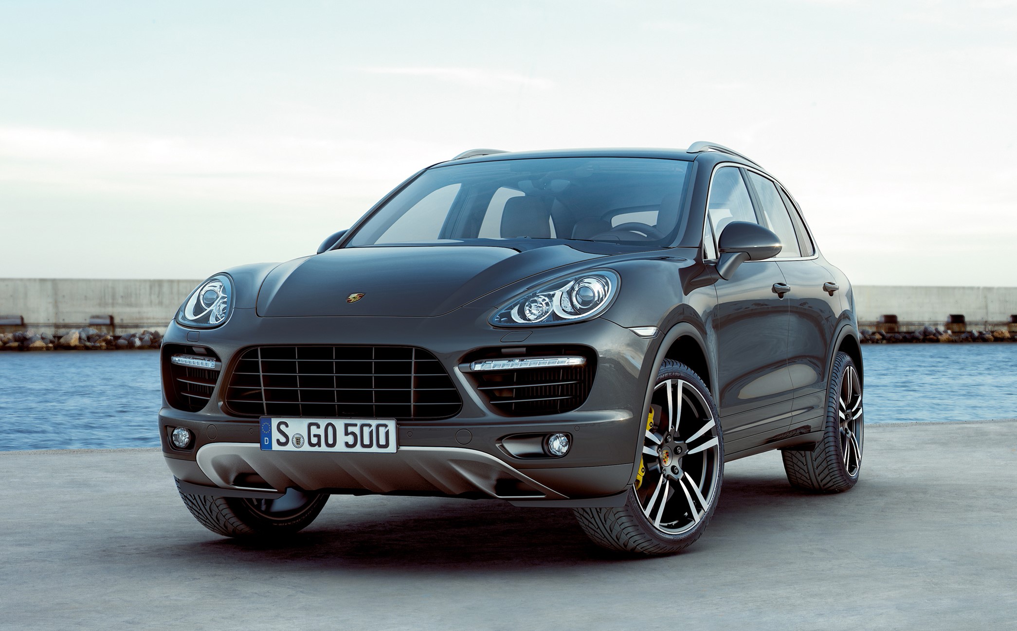 Porsche Cayenne parked by the water HD Wallpaper
