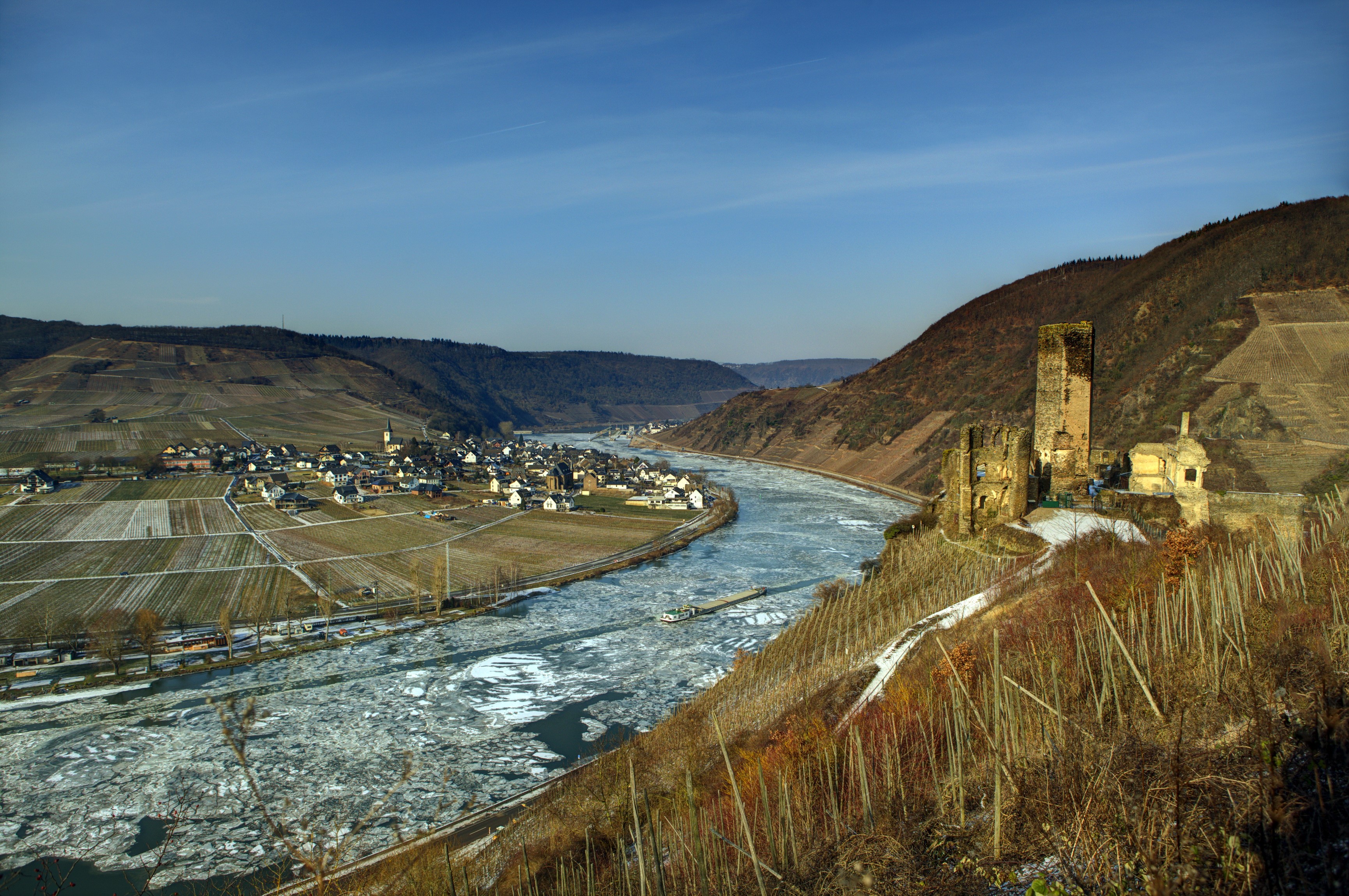 Ruins of a castle overlooking a frozen river and village in Germany HD Wallpaper