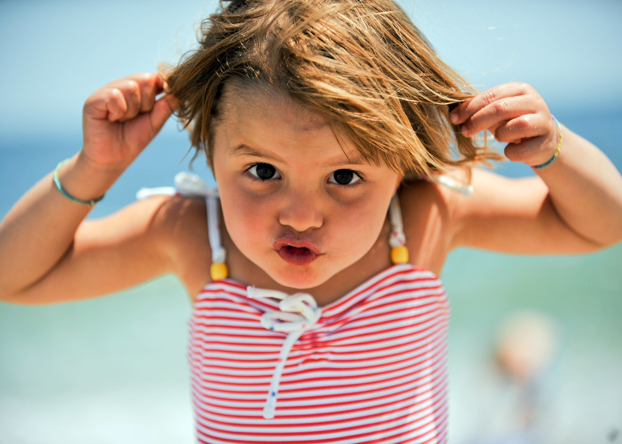 Girl making a funny face at the beach HD Wallpaper