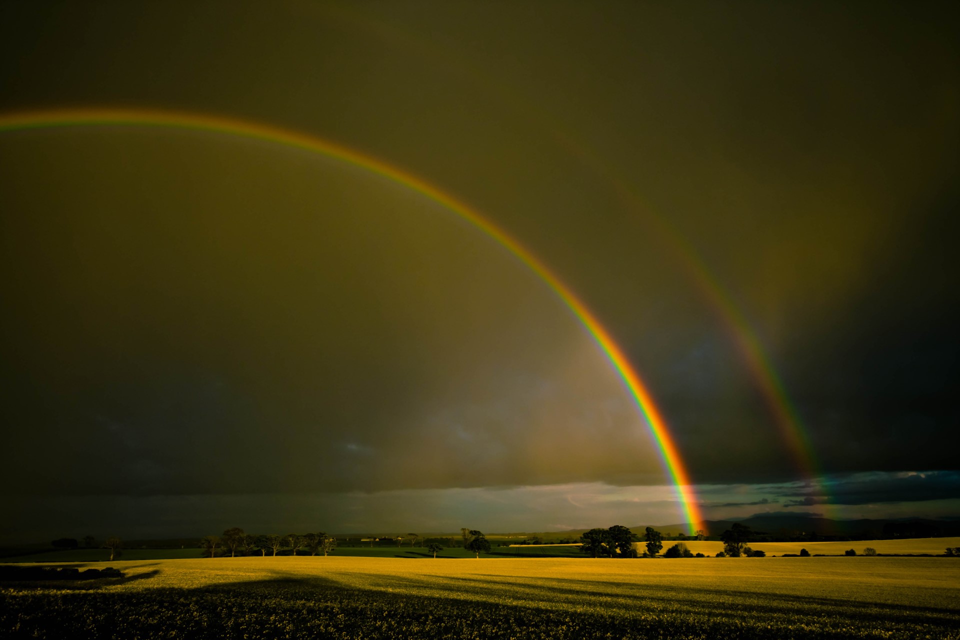 Double rainbow over a field at sunset HD Wallpaper