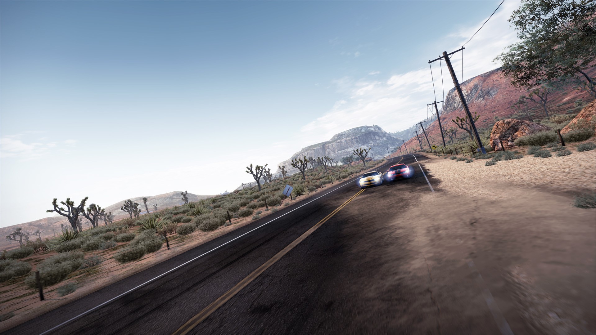 Cars racing on a desert road in Need for Speed Hot Pursuit HD Wallpaper