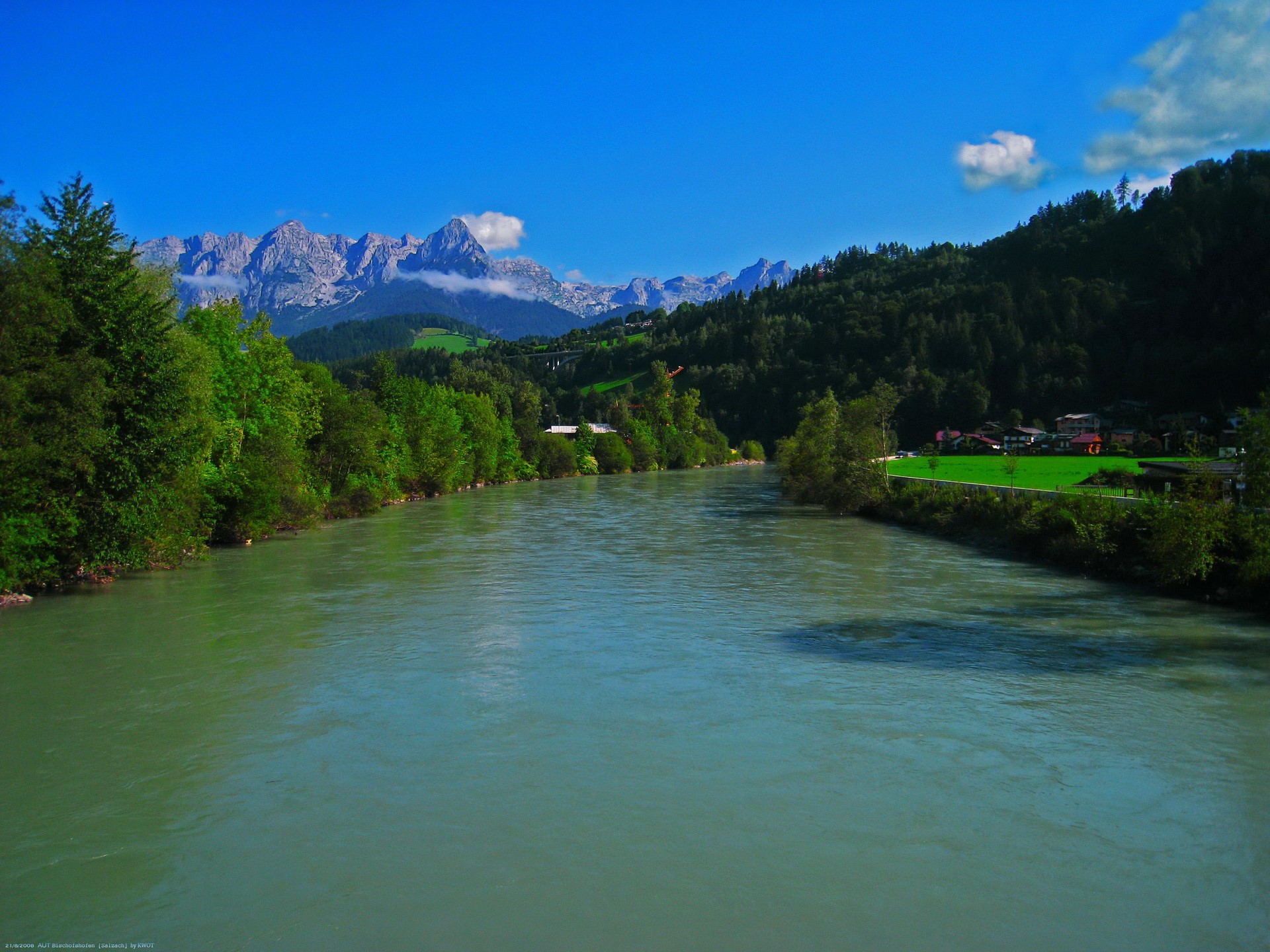 River flowing through a valley with mountains HD Wallpaper