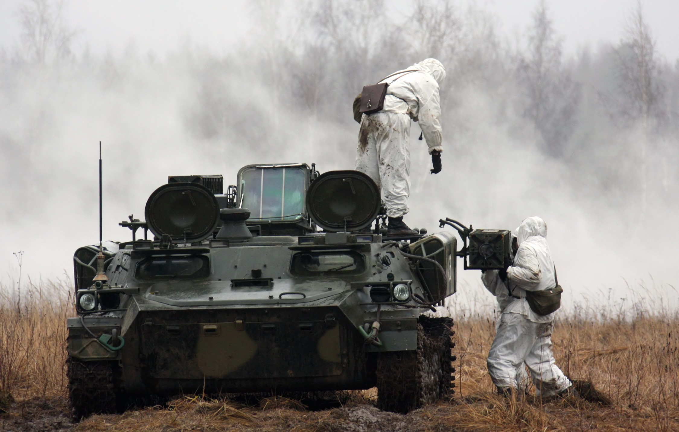 Soldiers in white camouflage suits with a military vehicle HD Wallpaper