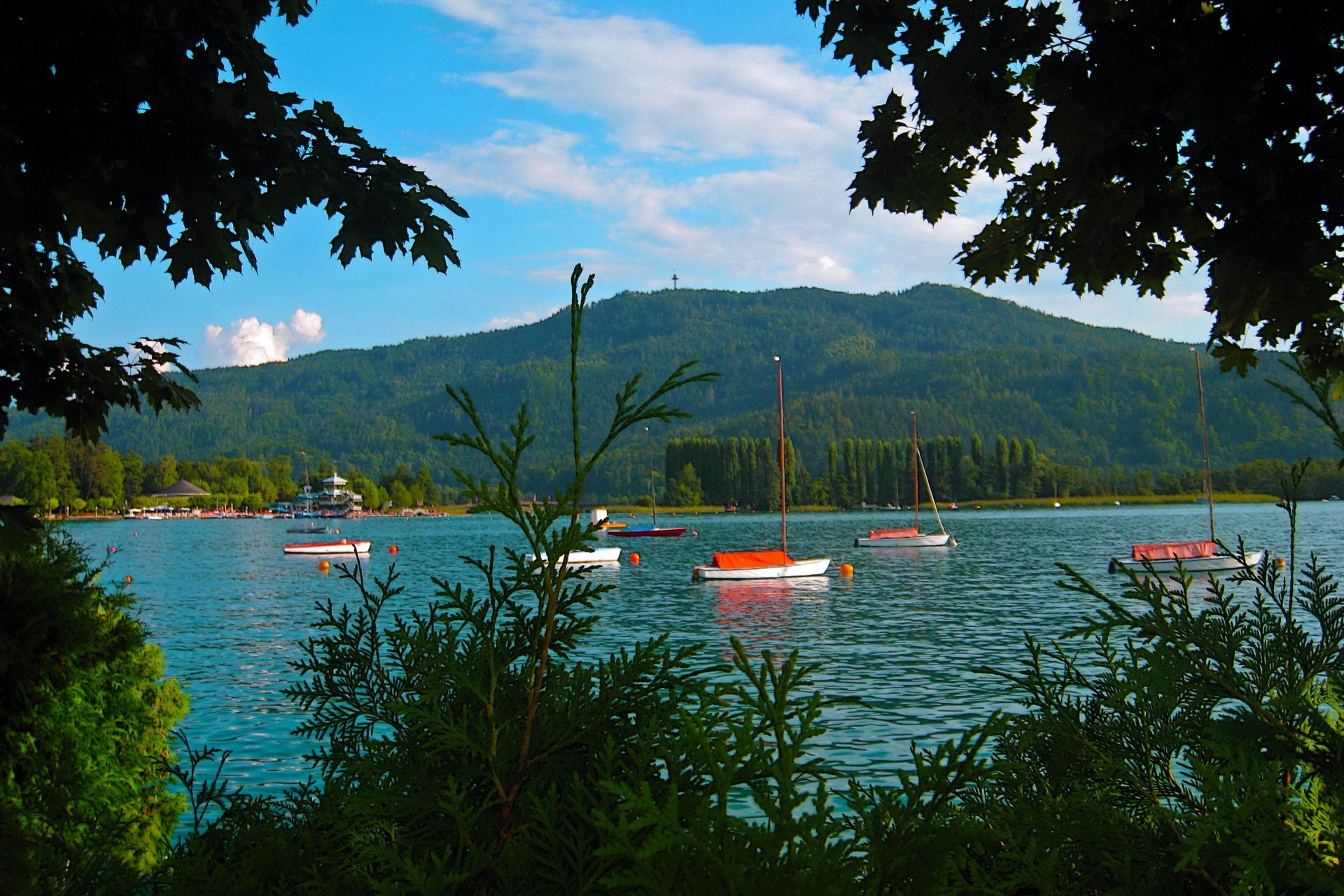 Boats on a lake with a mountain in the background HD Wallpaper