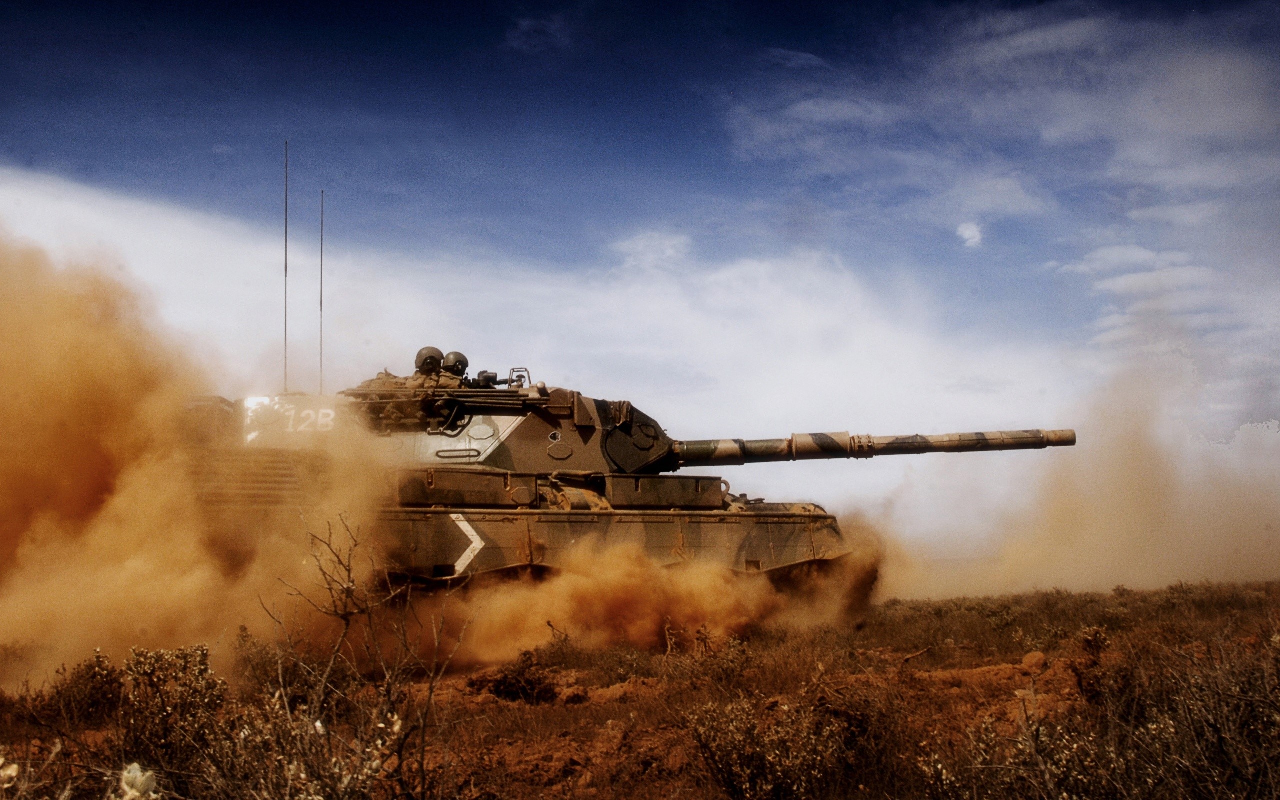 Tank moving through dust and brush HD Wallpaper