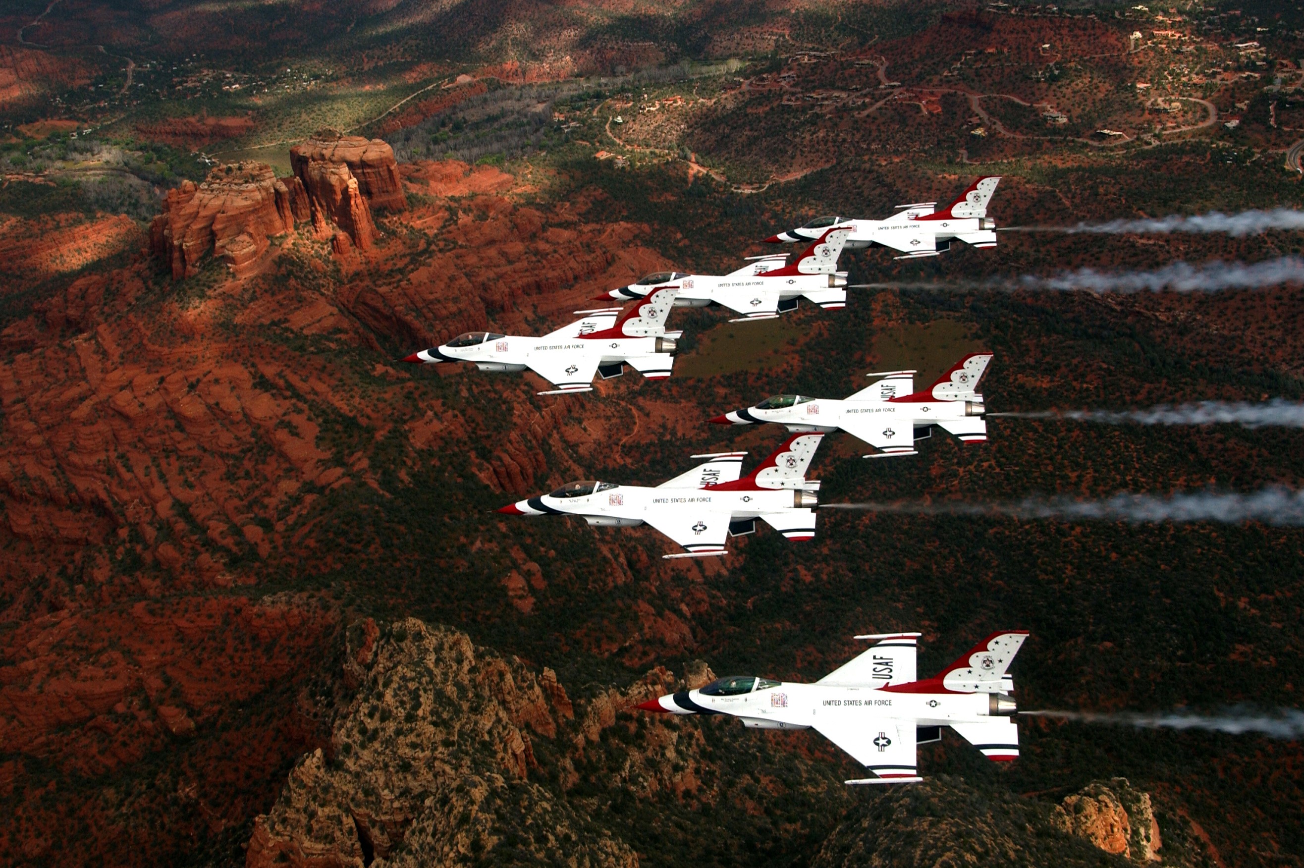 US Air Force Thunderbirds flying over red rock formations HD Wallpaper