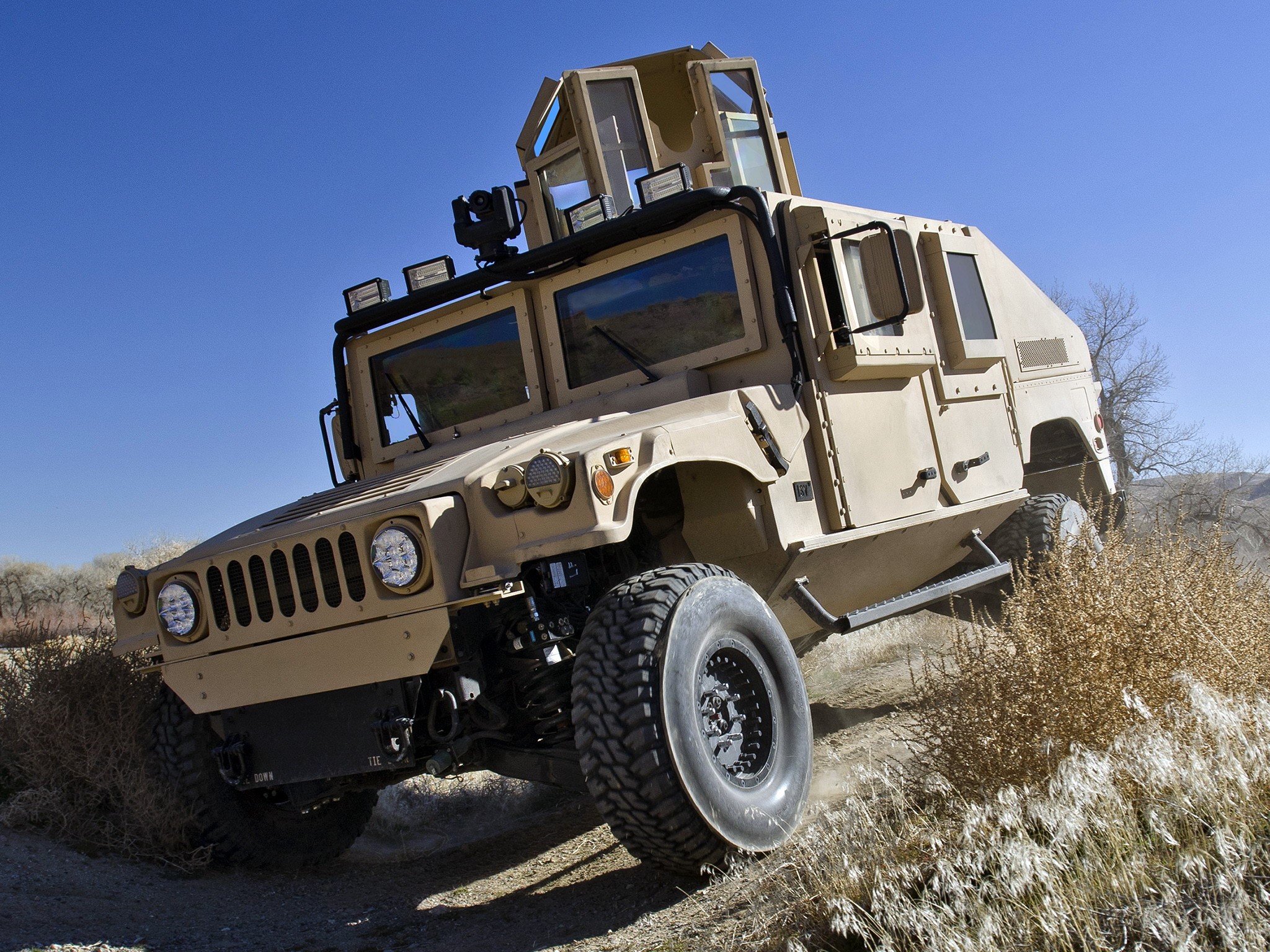 Tan Humvee military vehicle on dirt road HD Wallpaper